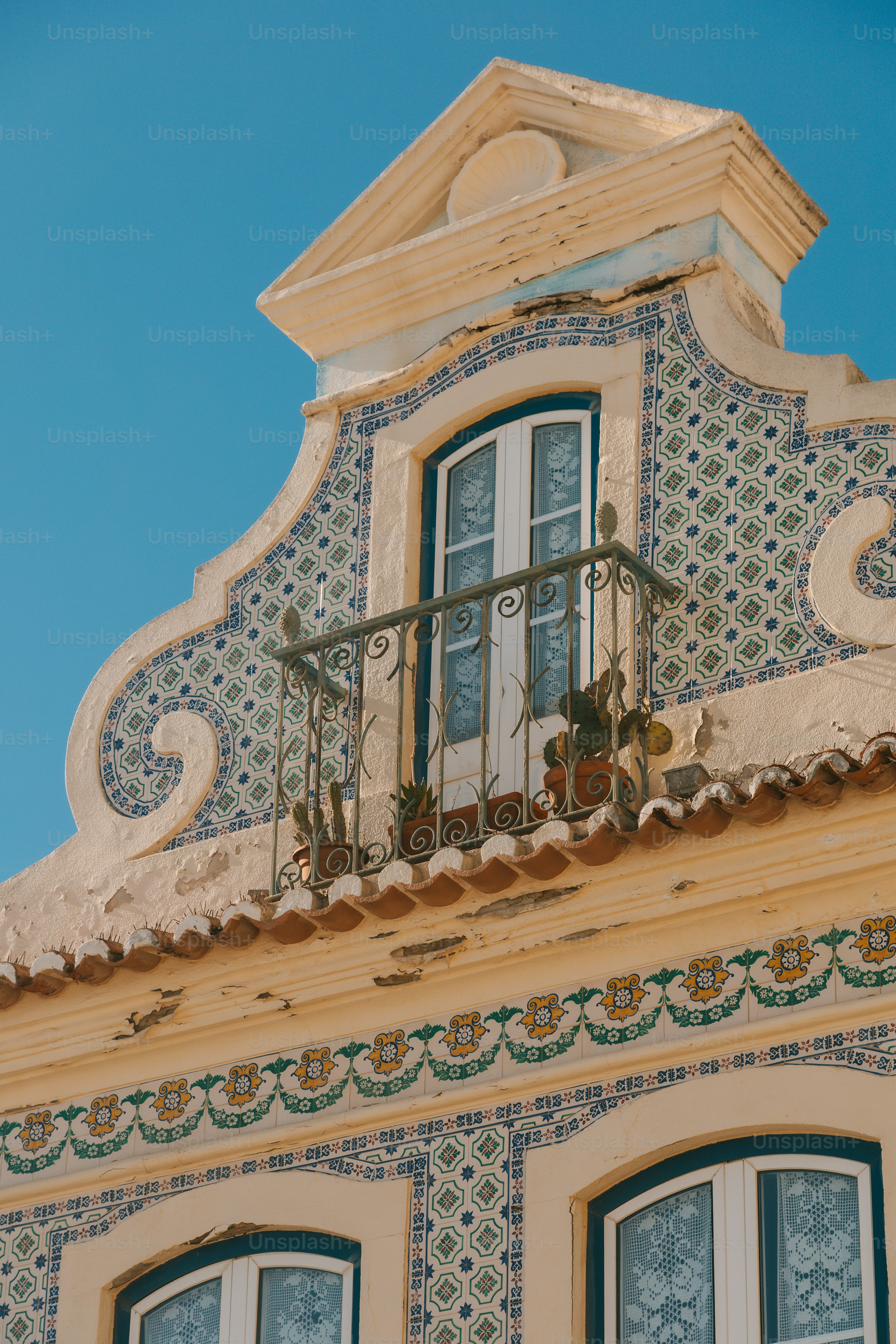 Ornate building facade with tiled patterns and balcony