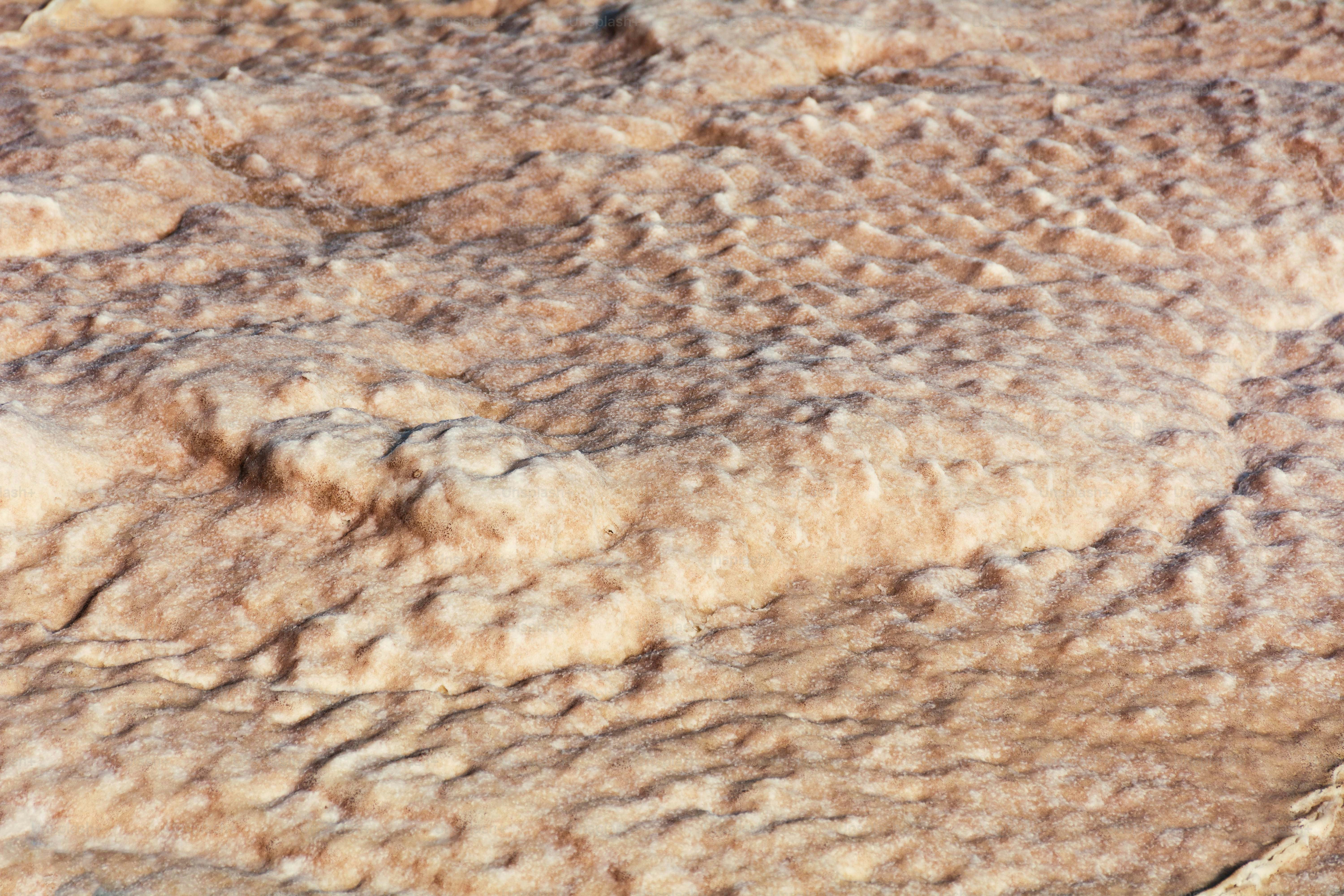 Close-up of textured sand dunes under sunlight