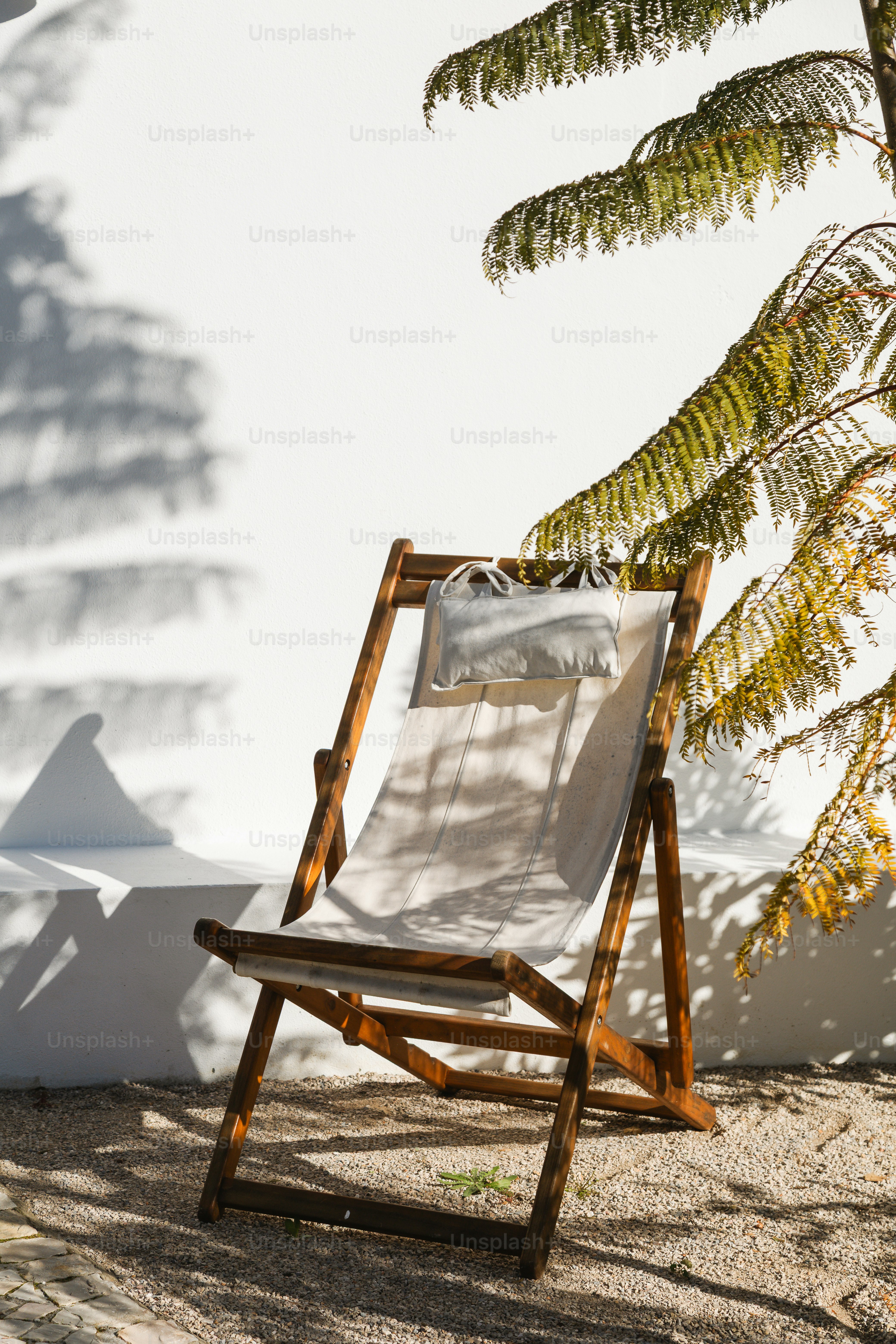 Wooden deck chair with cushion on sunny patio. photo – Travel Image on ...
