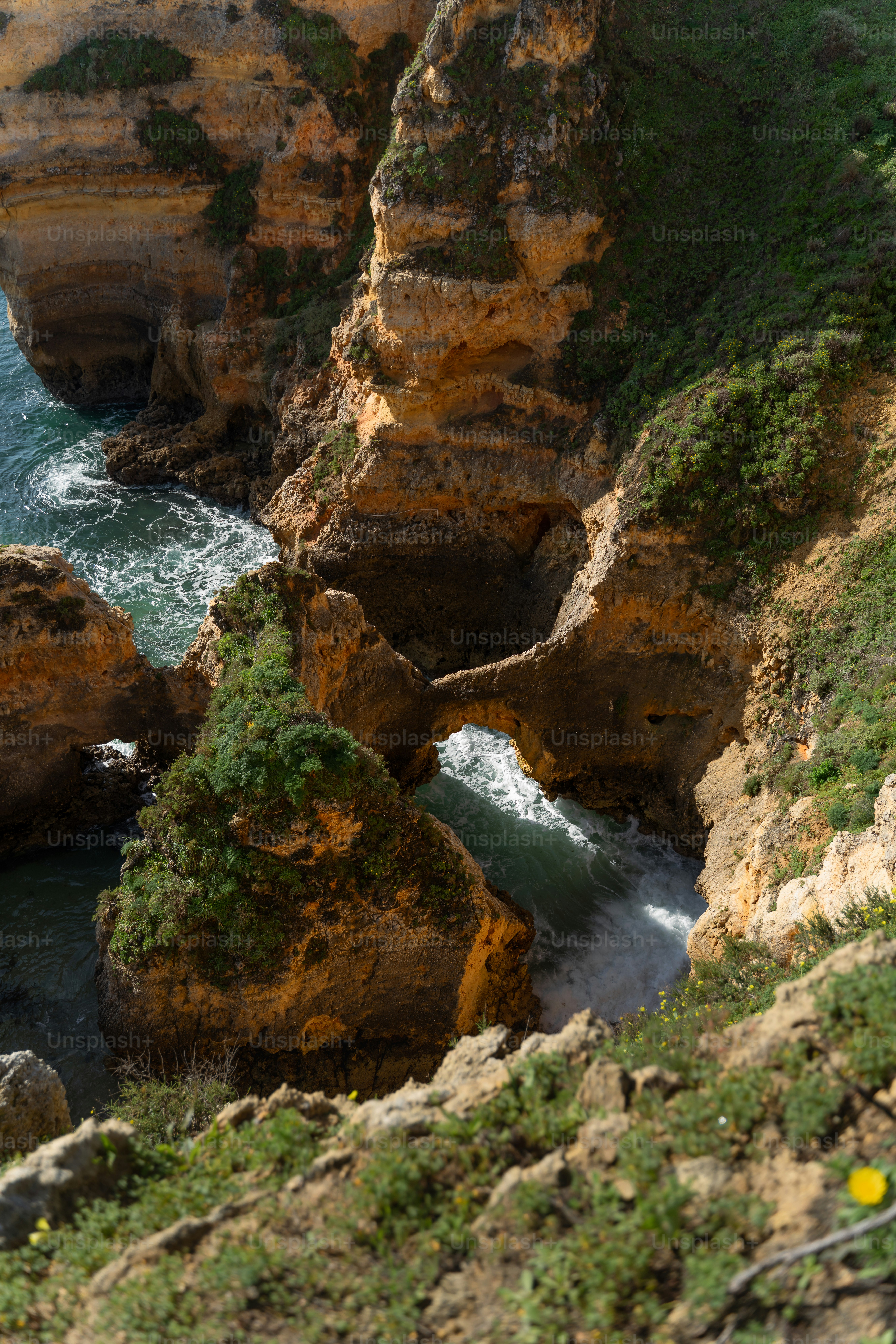 Rocky coastline with crashing waves and natural arch