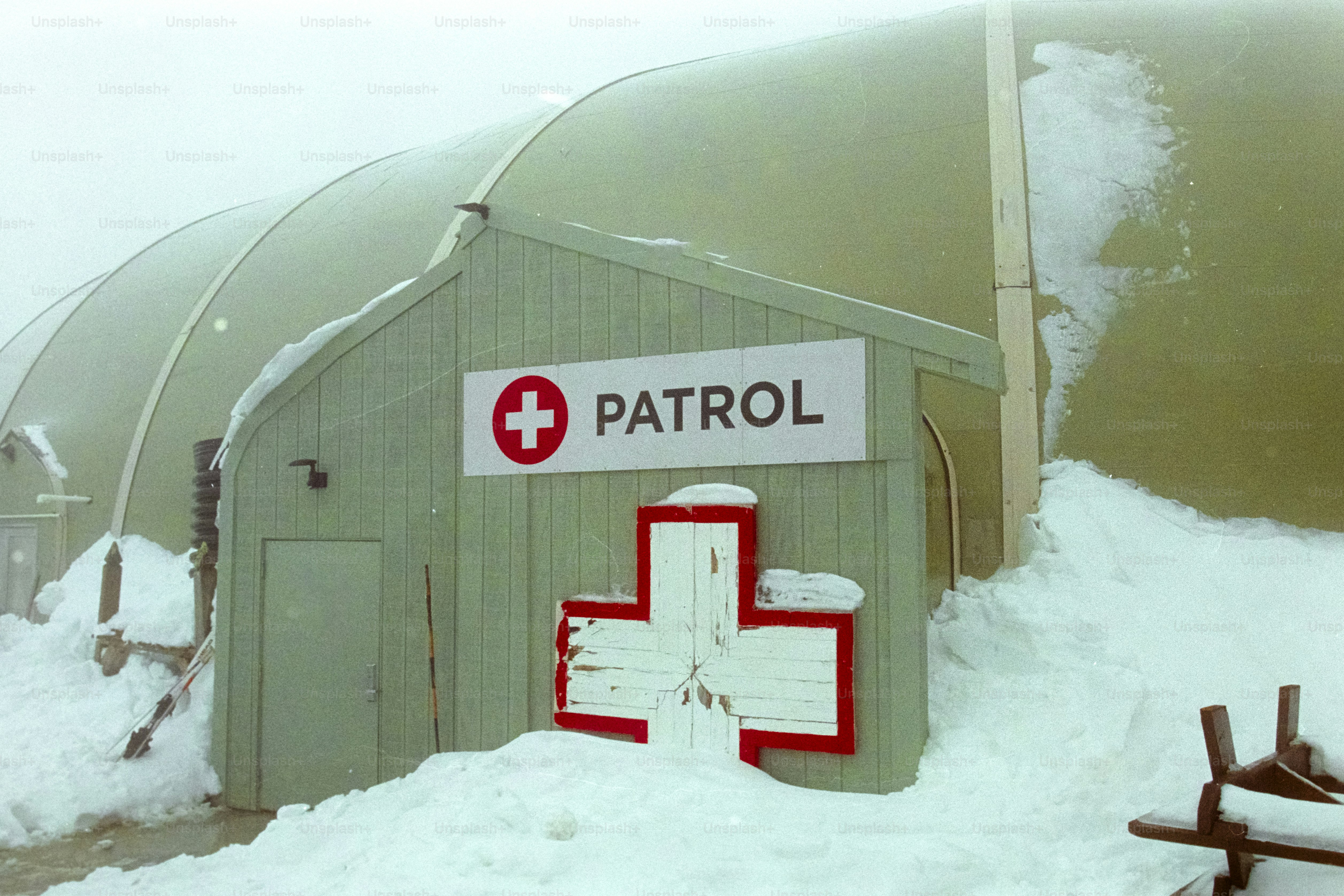 Patrol building with a red cross in snow