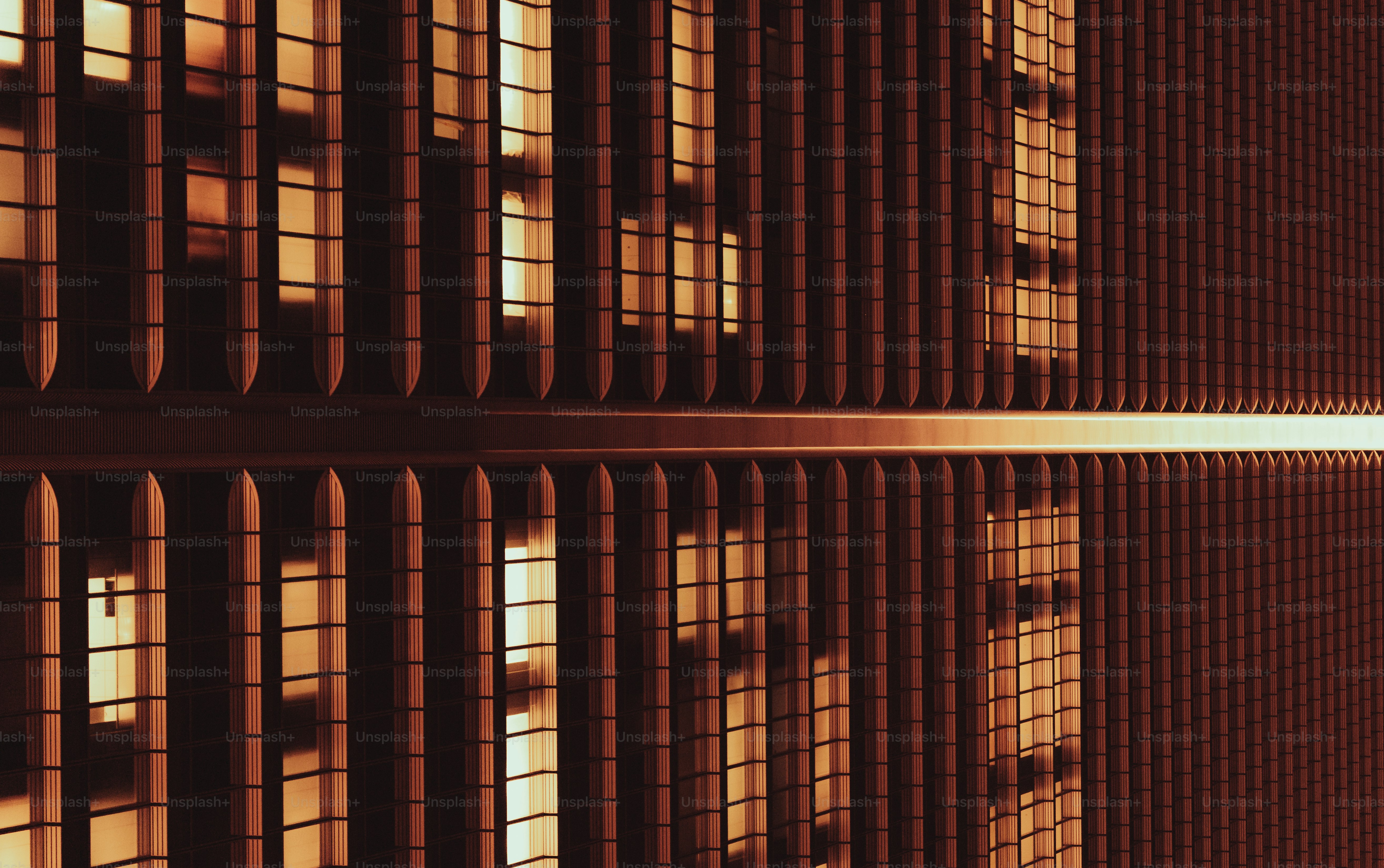 Modern building facade with warm lighting and reflection