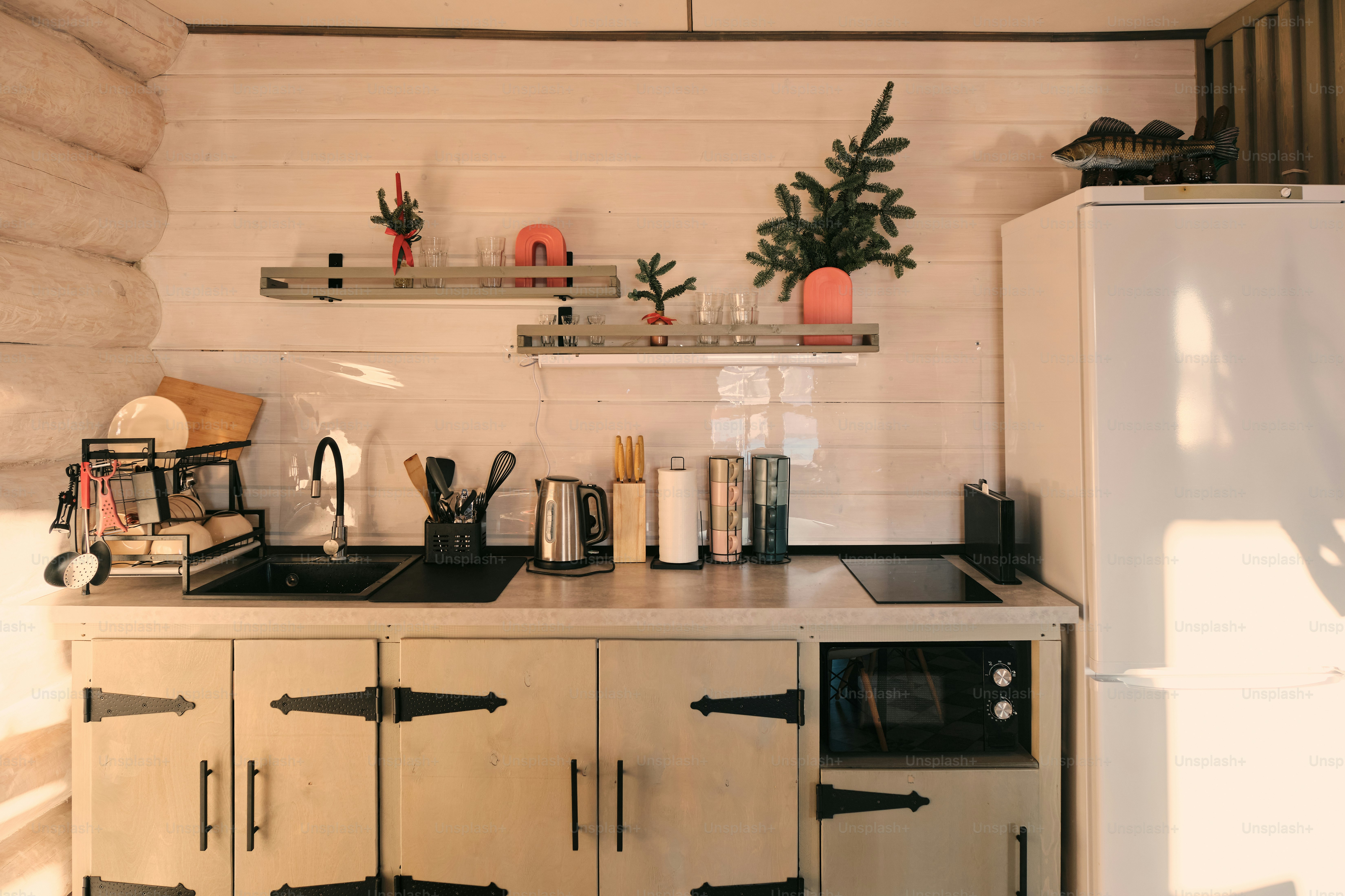 Cozy kitchen with wooden cabinets and white refrigerator. photo ...