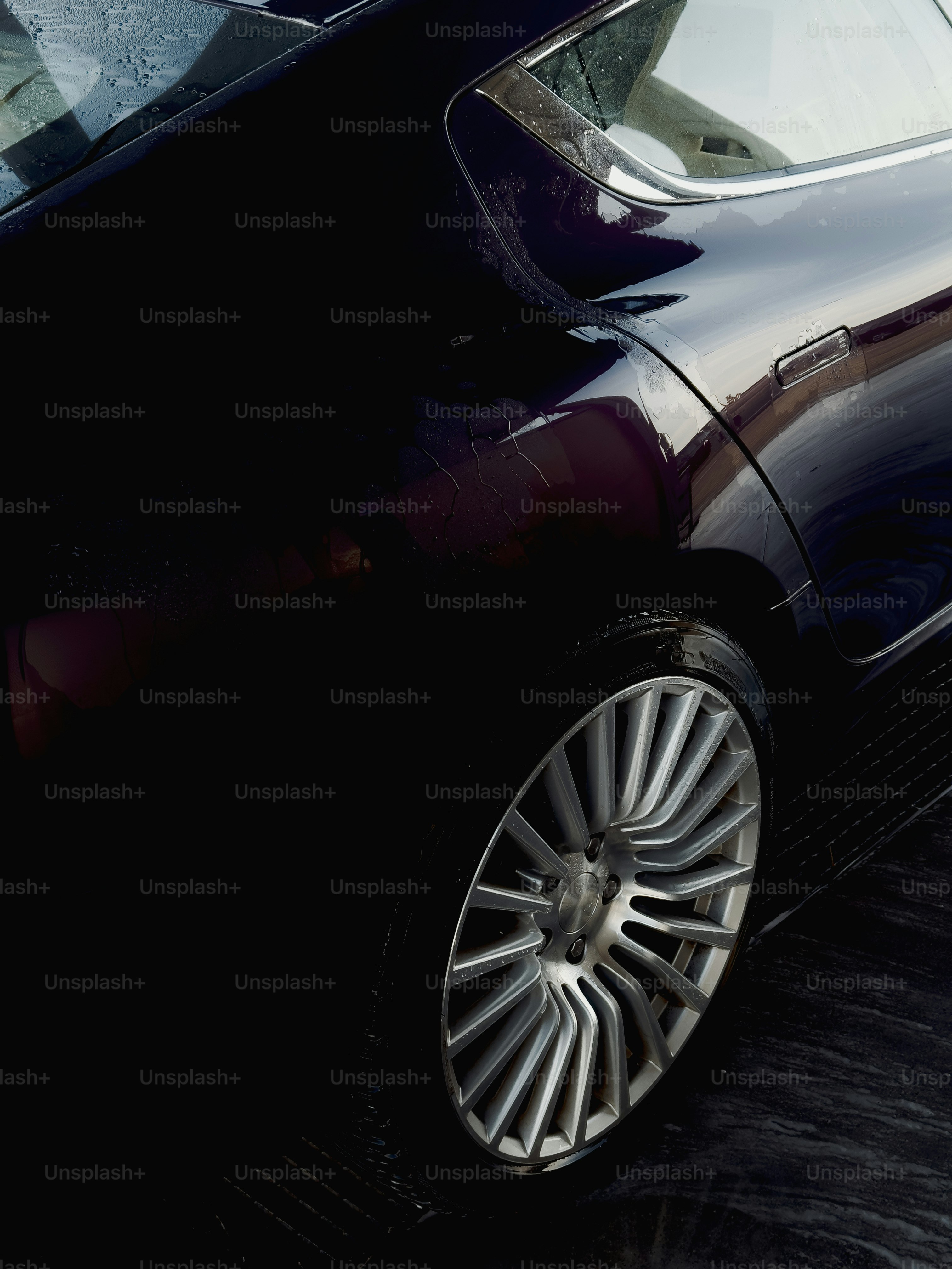 Dark luxury car wheel and body detail