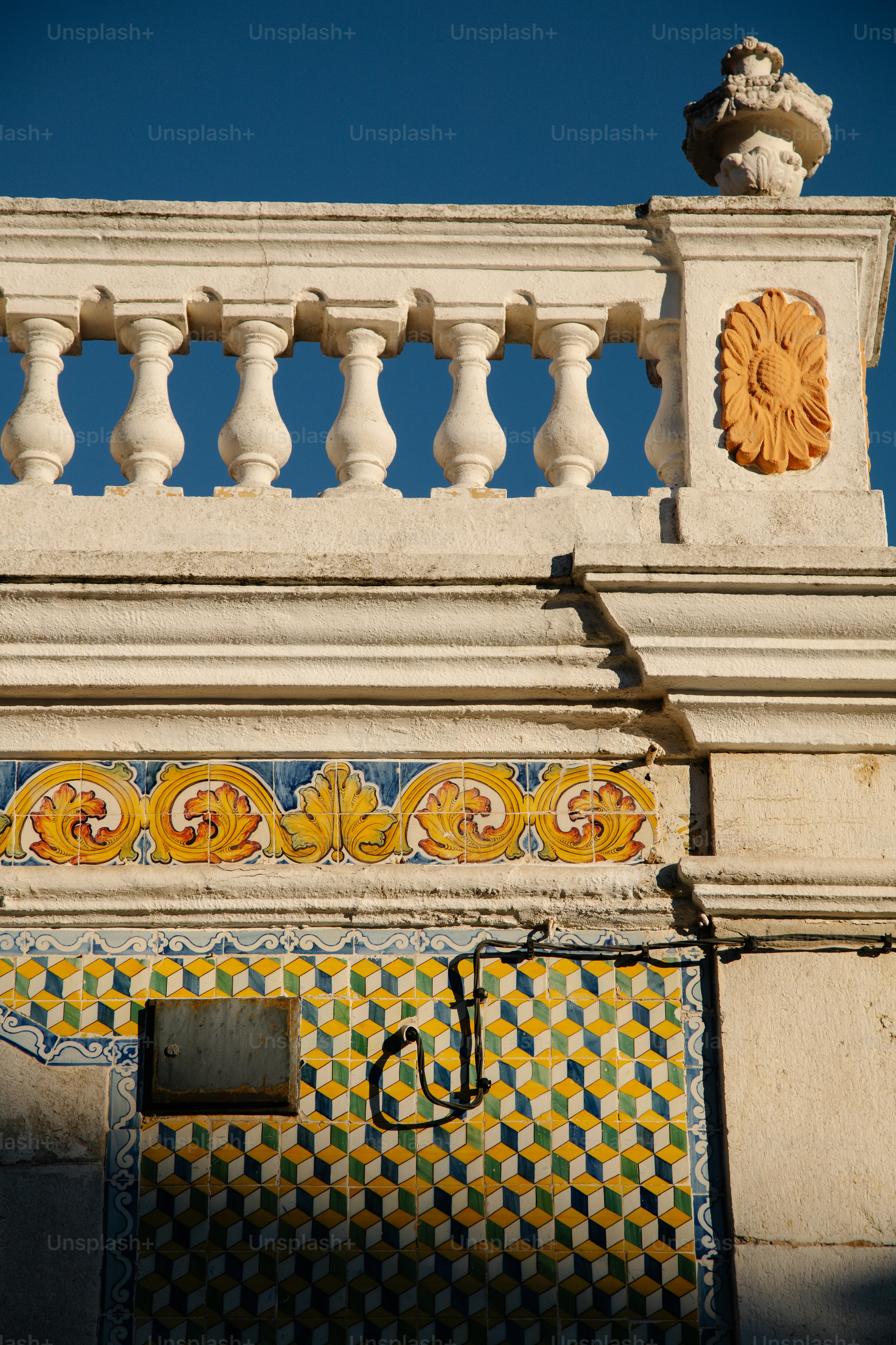 Ornate building facade with colorful tiled patterns photo – Blue sky ...