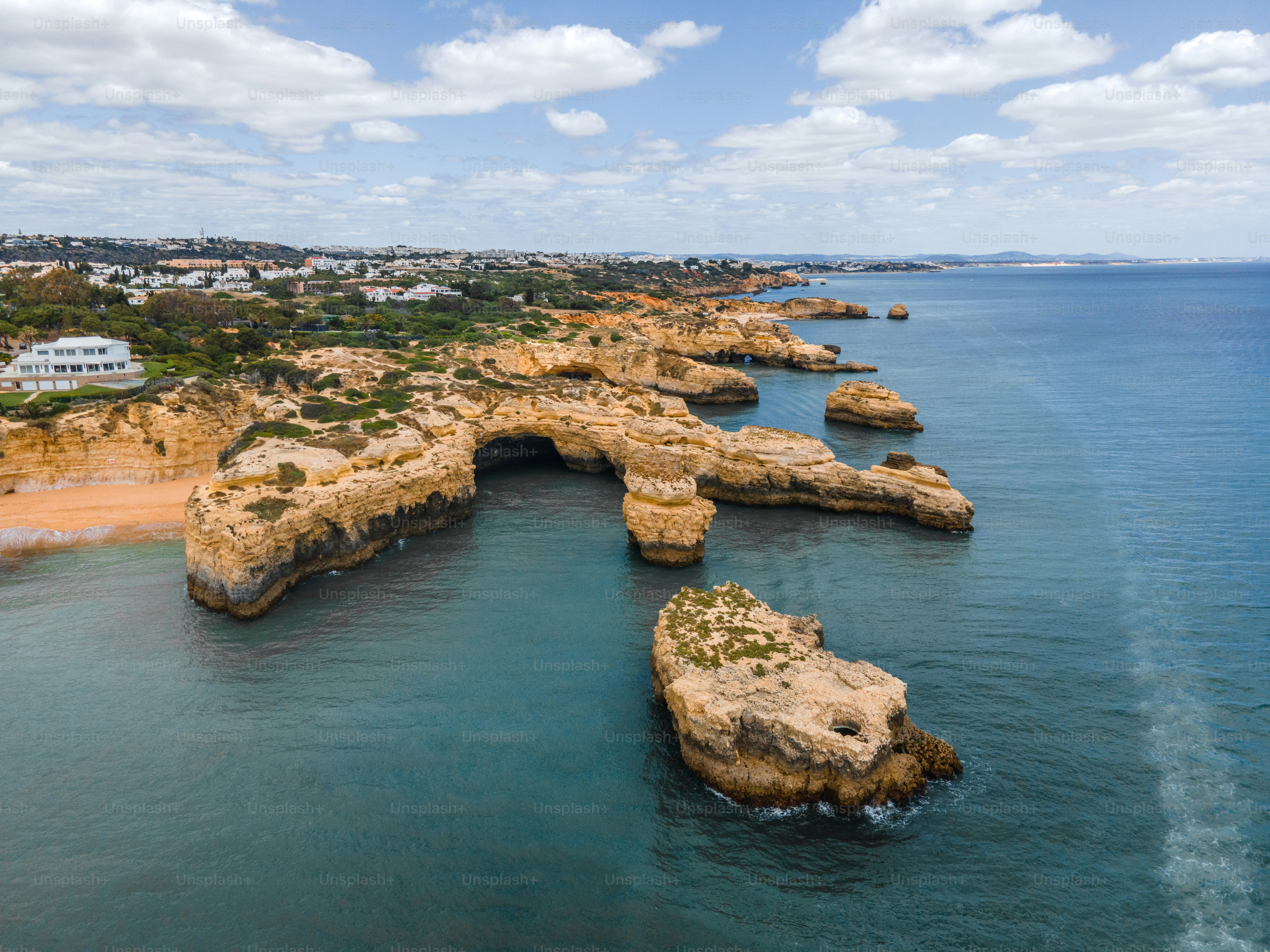 Coastal rock formations jutting into the blue ocean water.