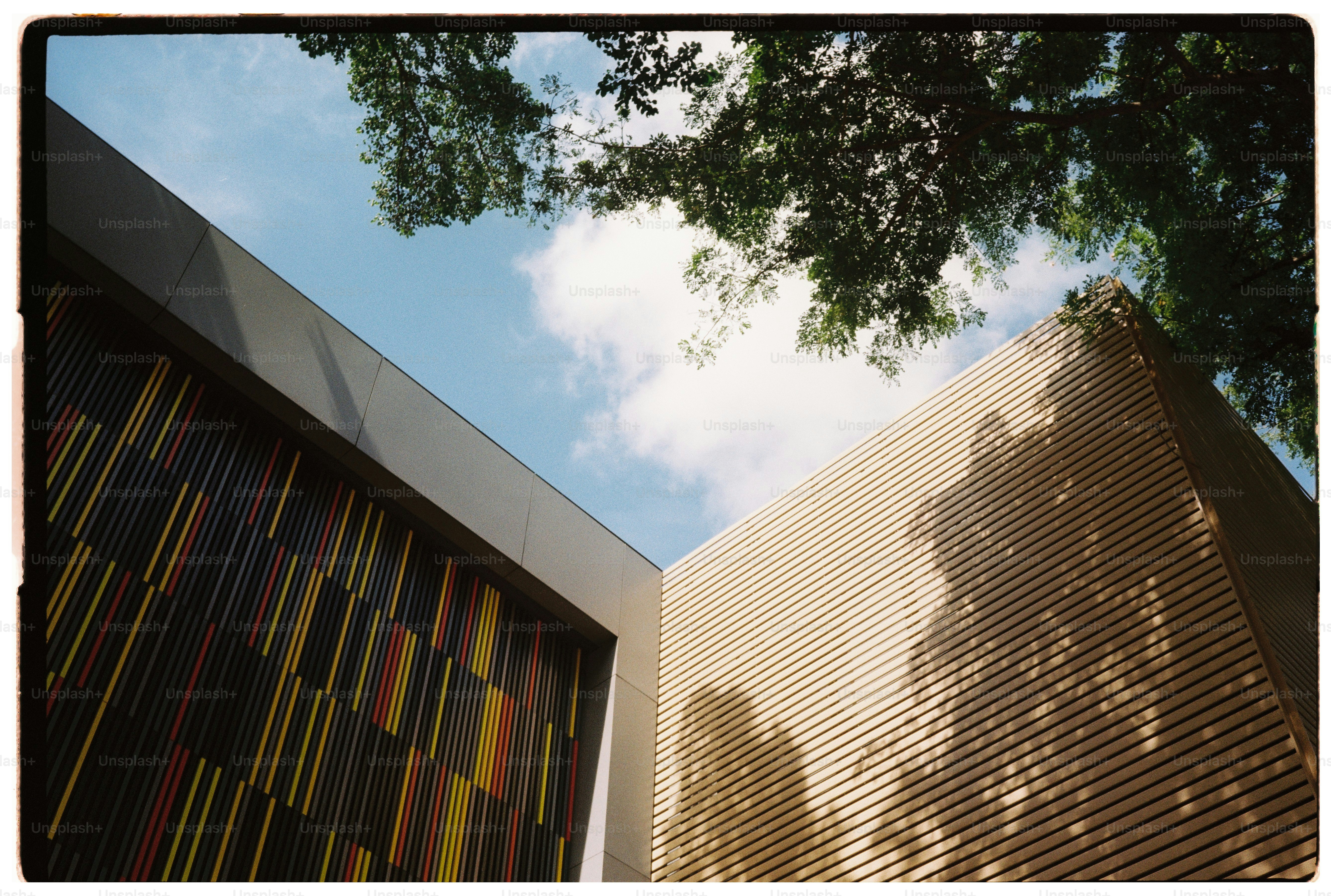 Modern building exterior with colorful facade and sky.