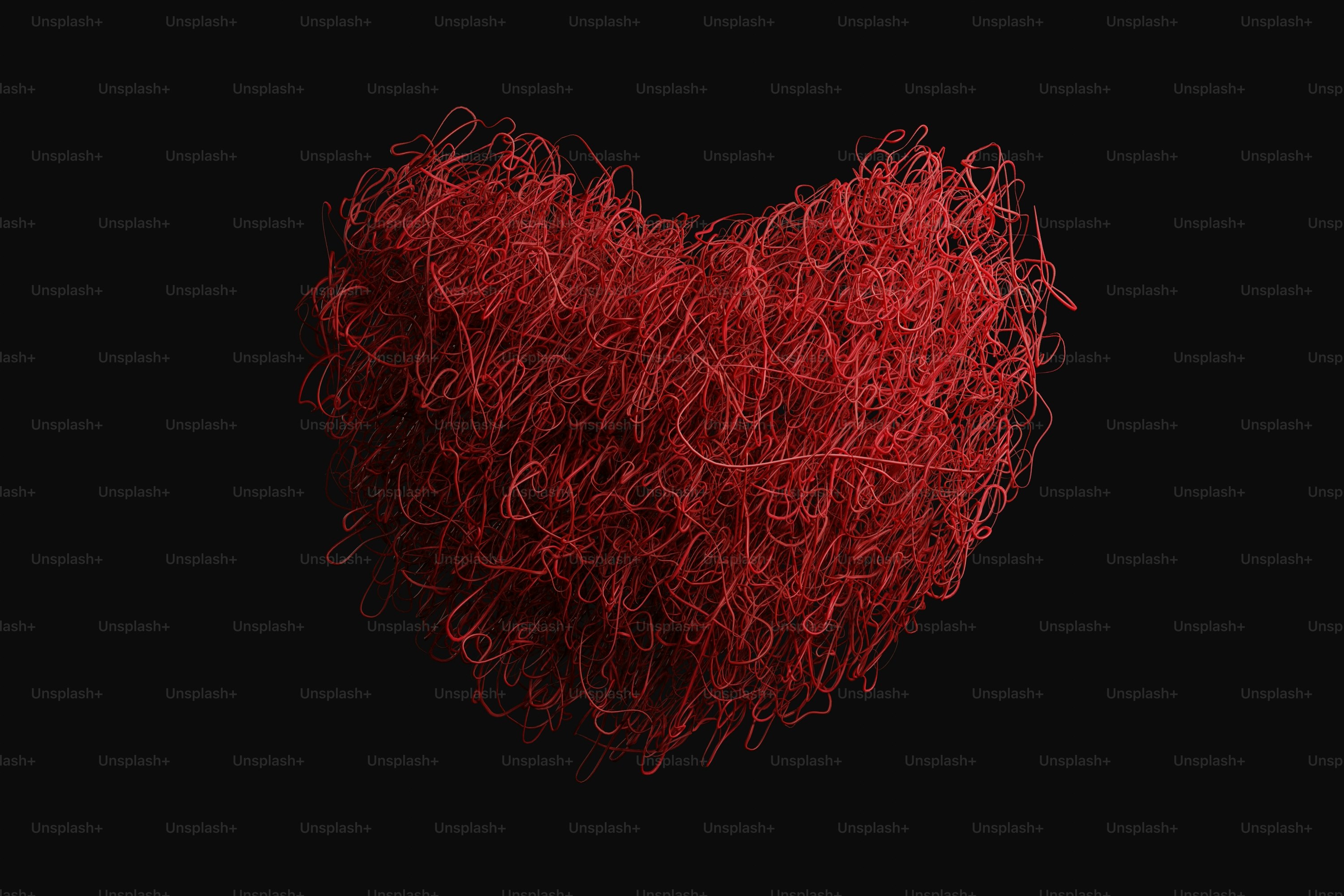 A red, tangled heart shape on black background