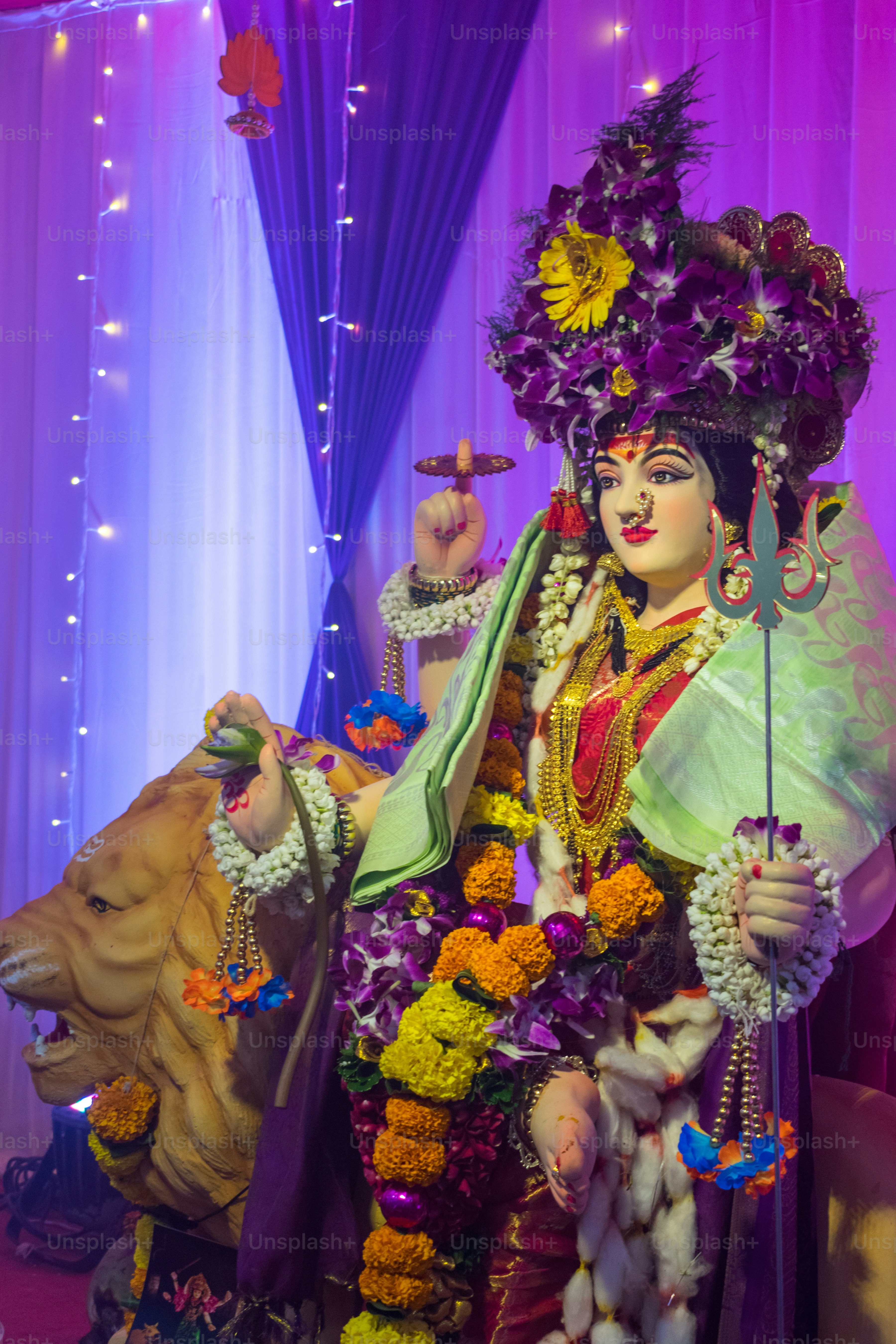 Goddess durga statue adorned with flowers and jewelry