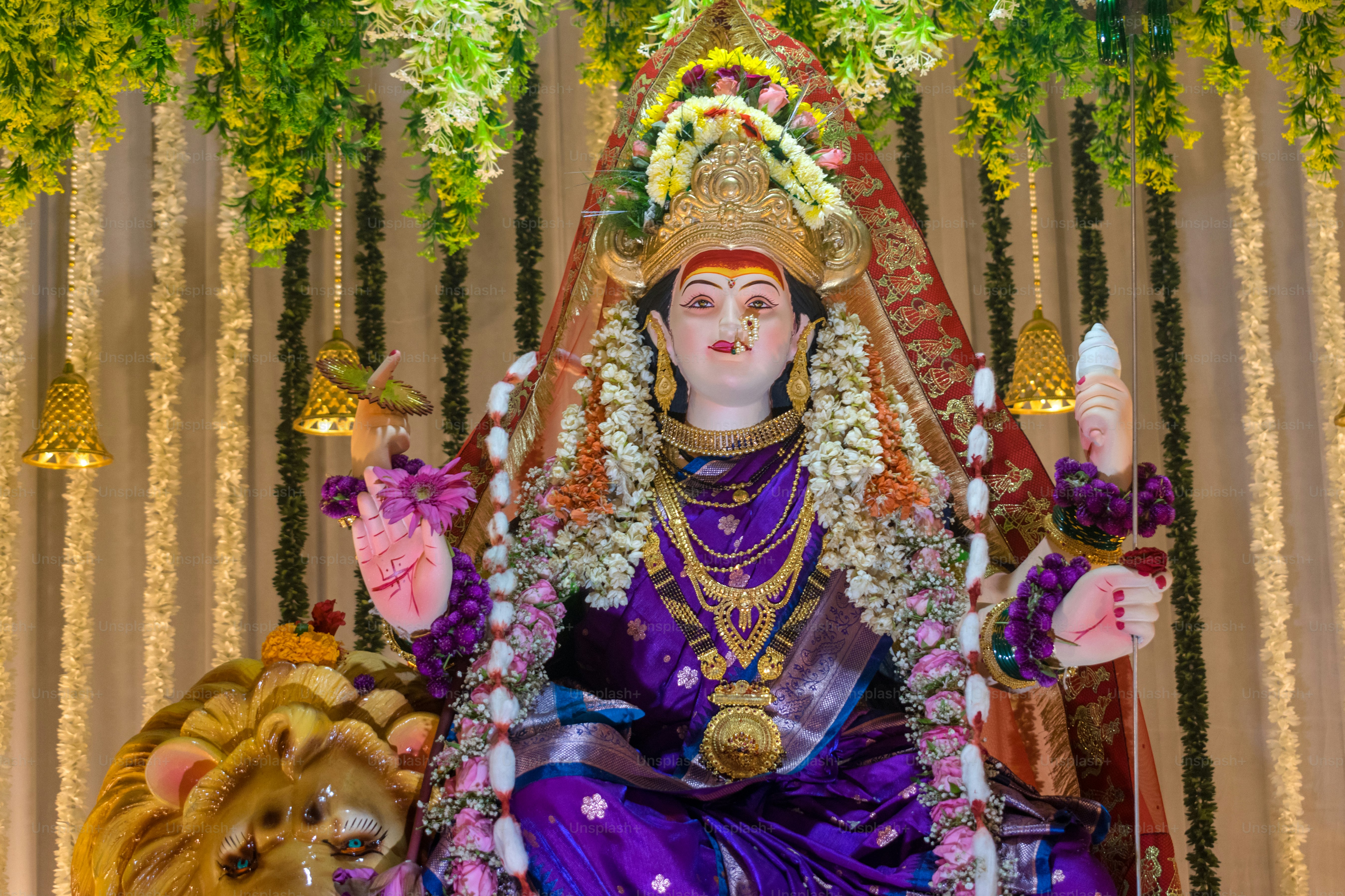 Statue of a hindu goddess adorned with jewelry.