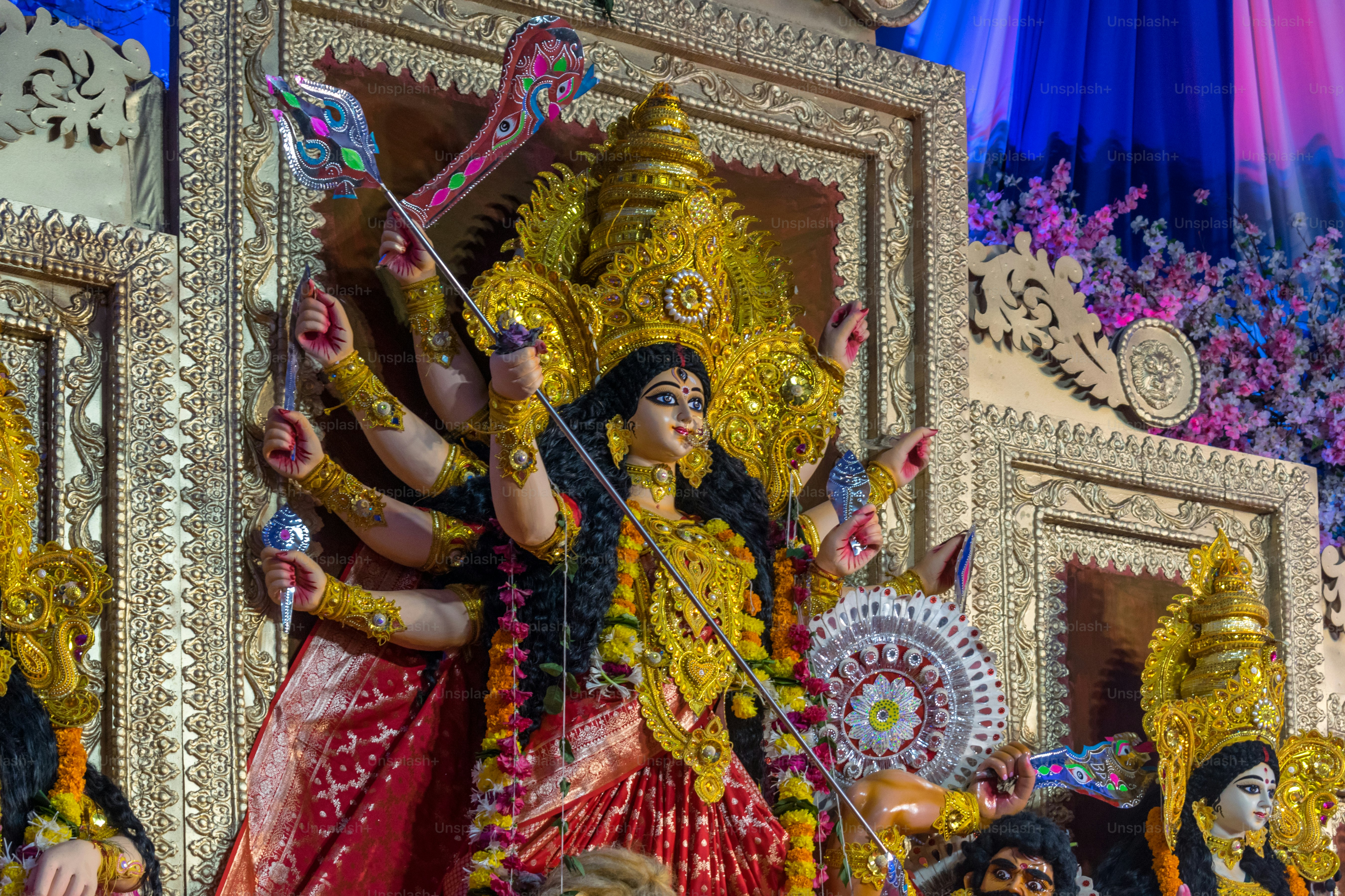Goddess durga statue with multiple arms and weapons