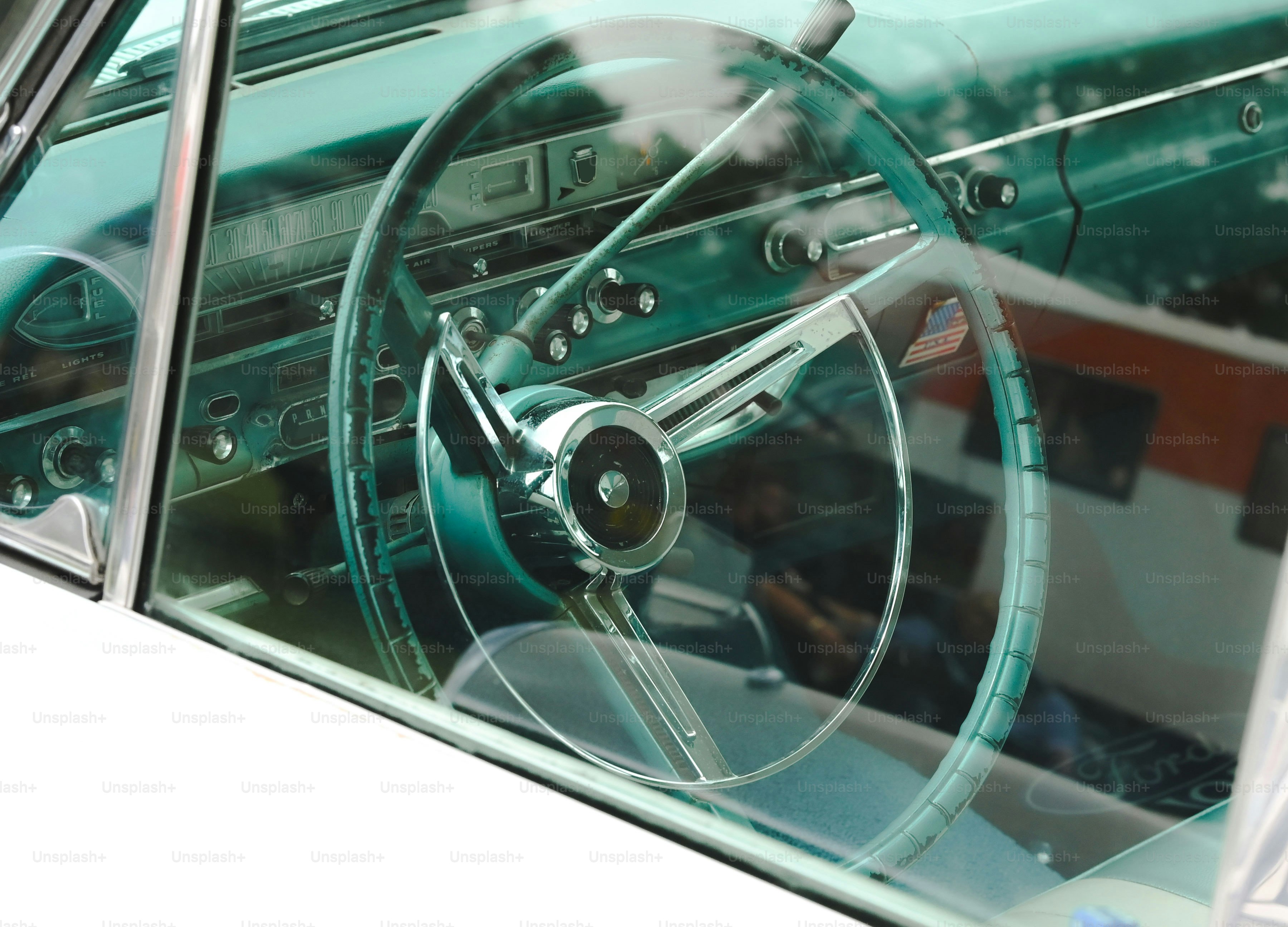 Vintage car steering wheel seen through window