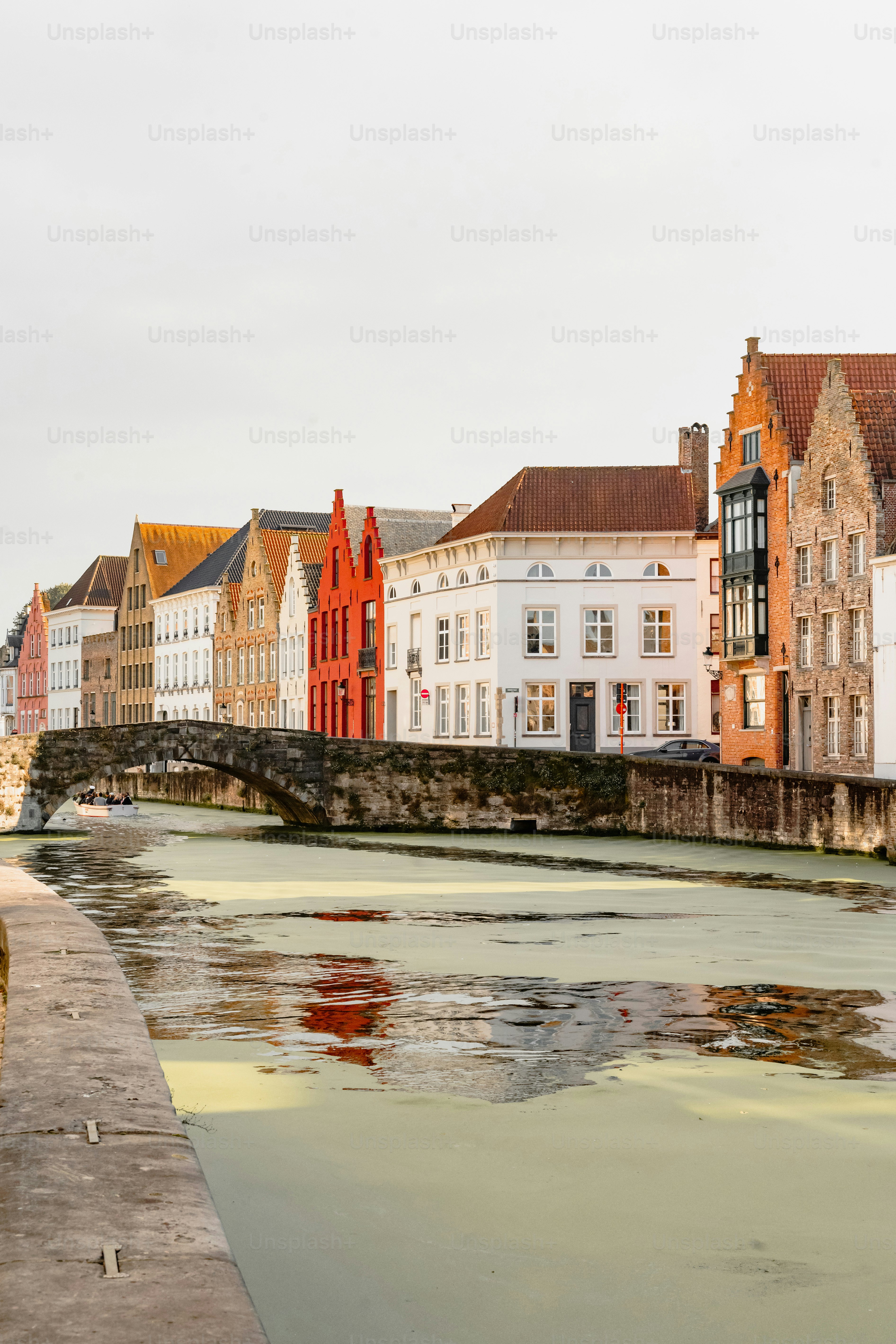 Canal and historic buildings with a bridge in bruges