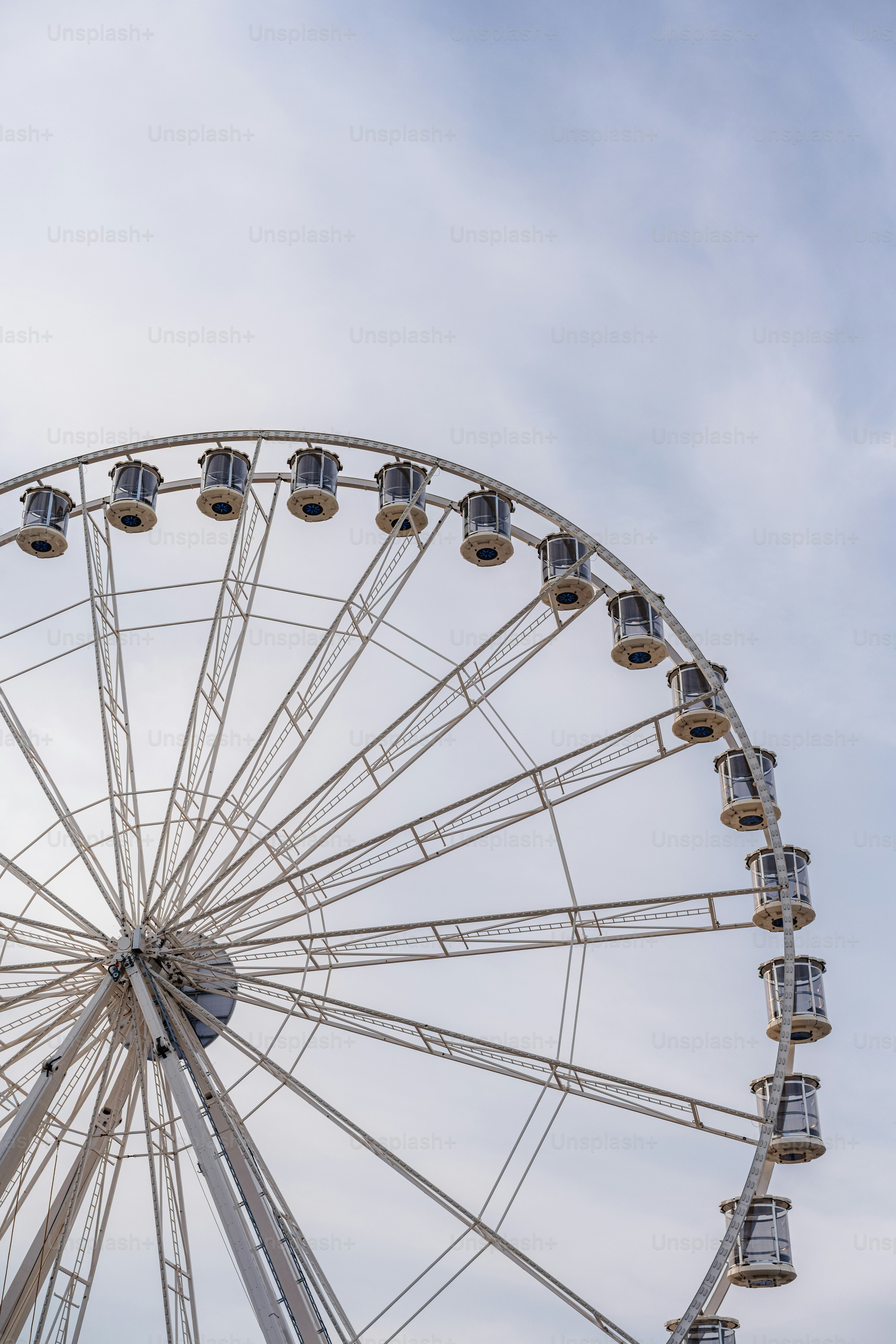 Una ruota panoramica bianca contro un cielo nuvoloso.
