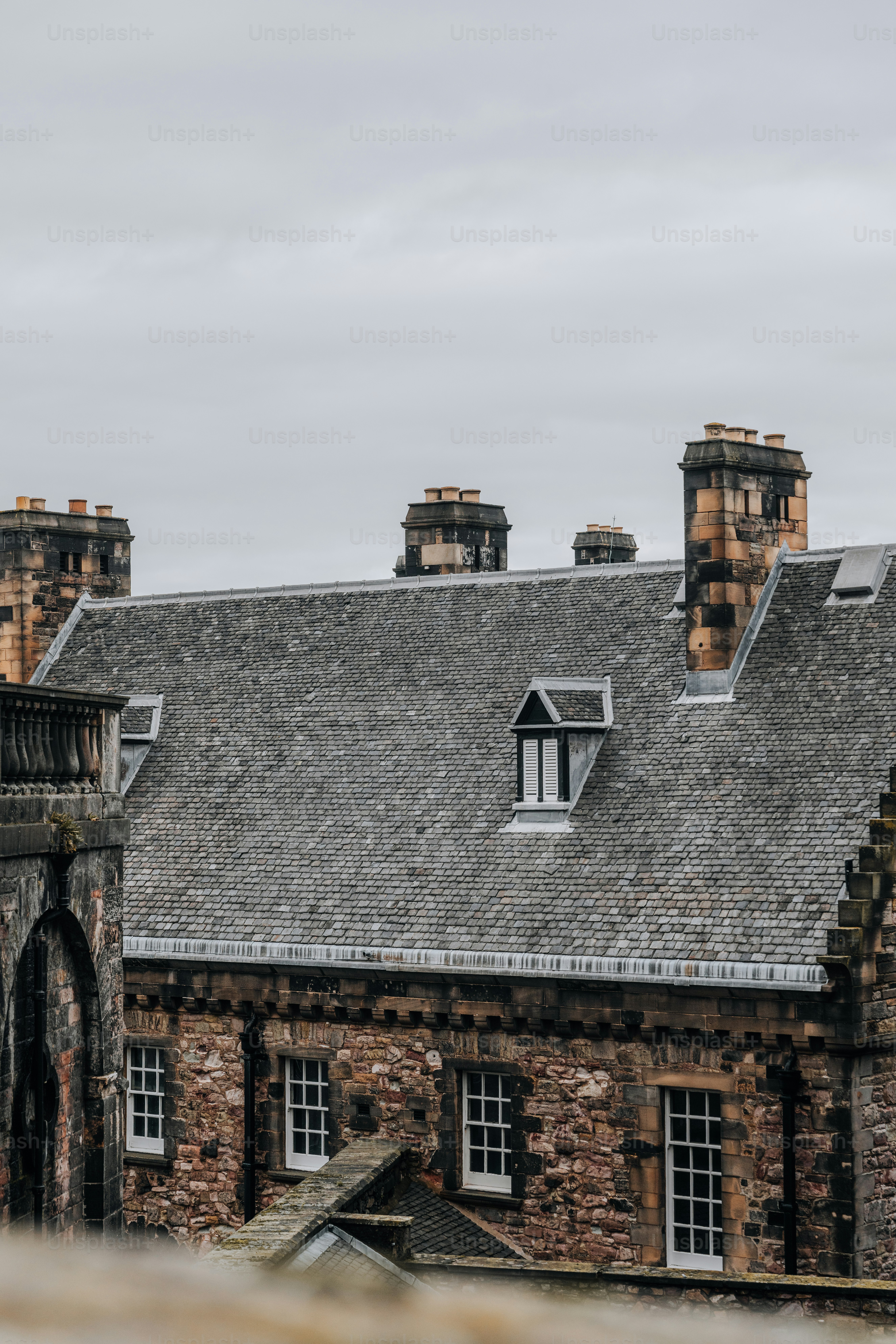 Historic stone building with multiple chimneys