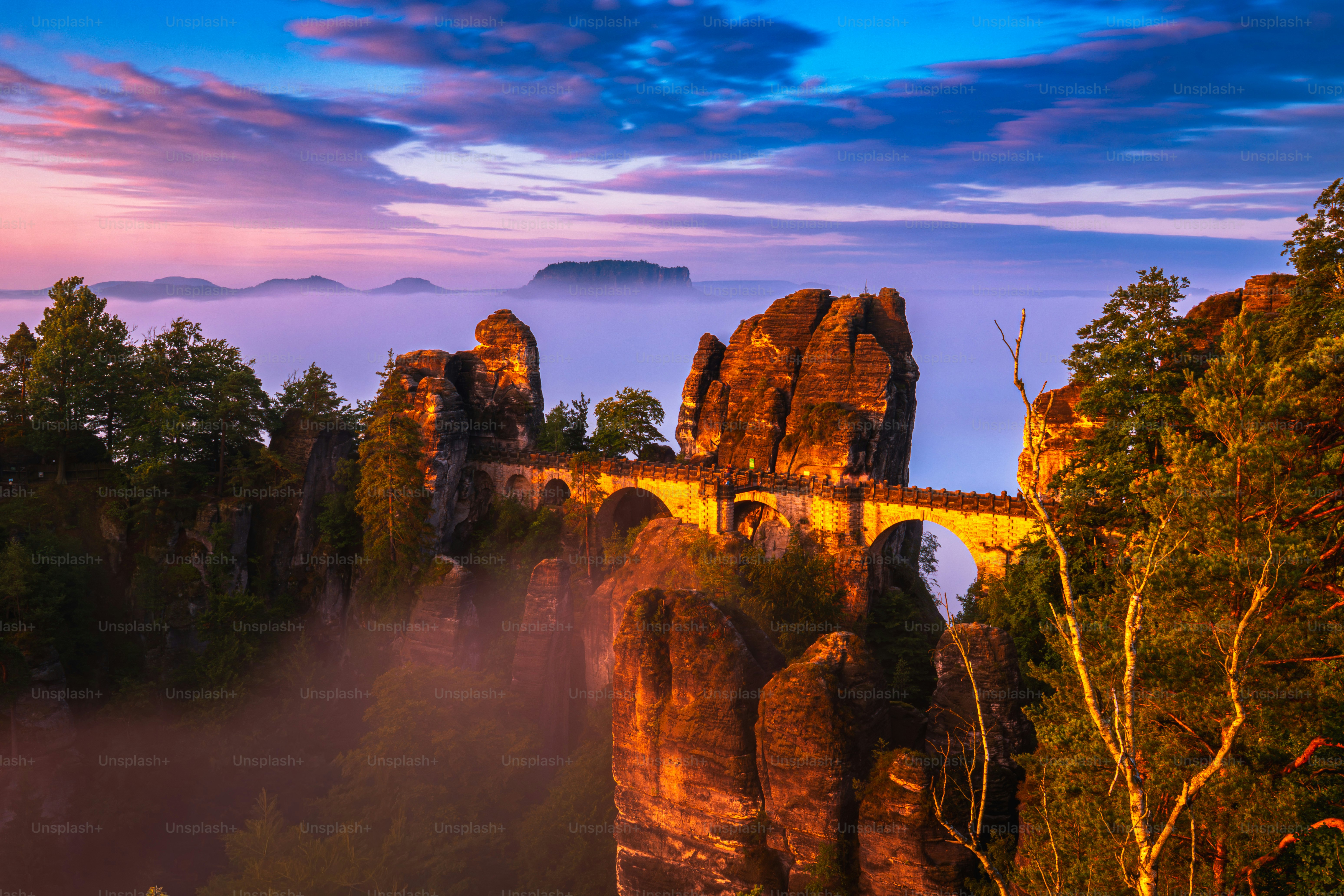Bastei bridge over misty elbe sandstone mountains at dawn