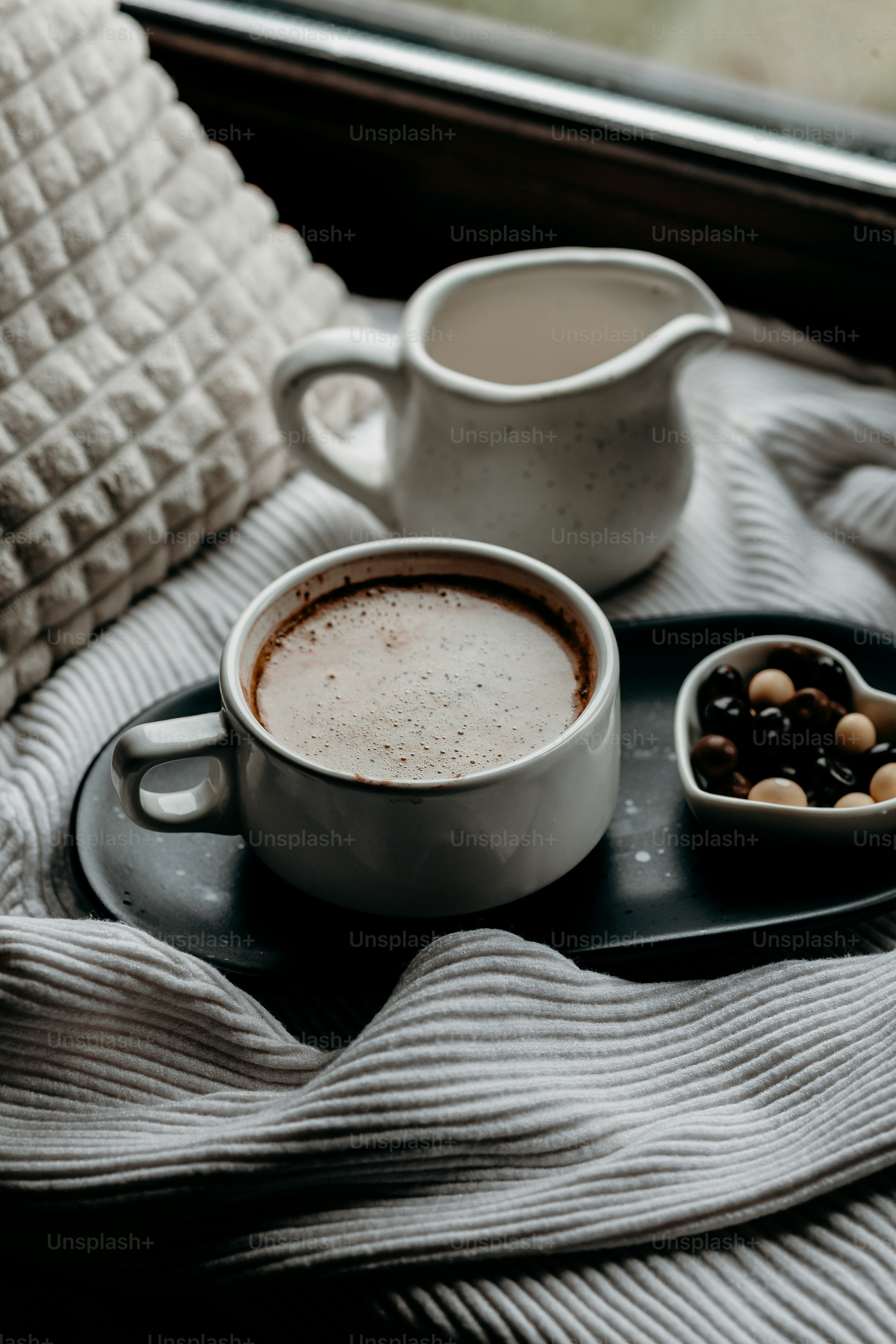 Cup of coffee with milk and chocolates