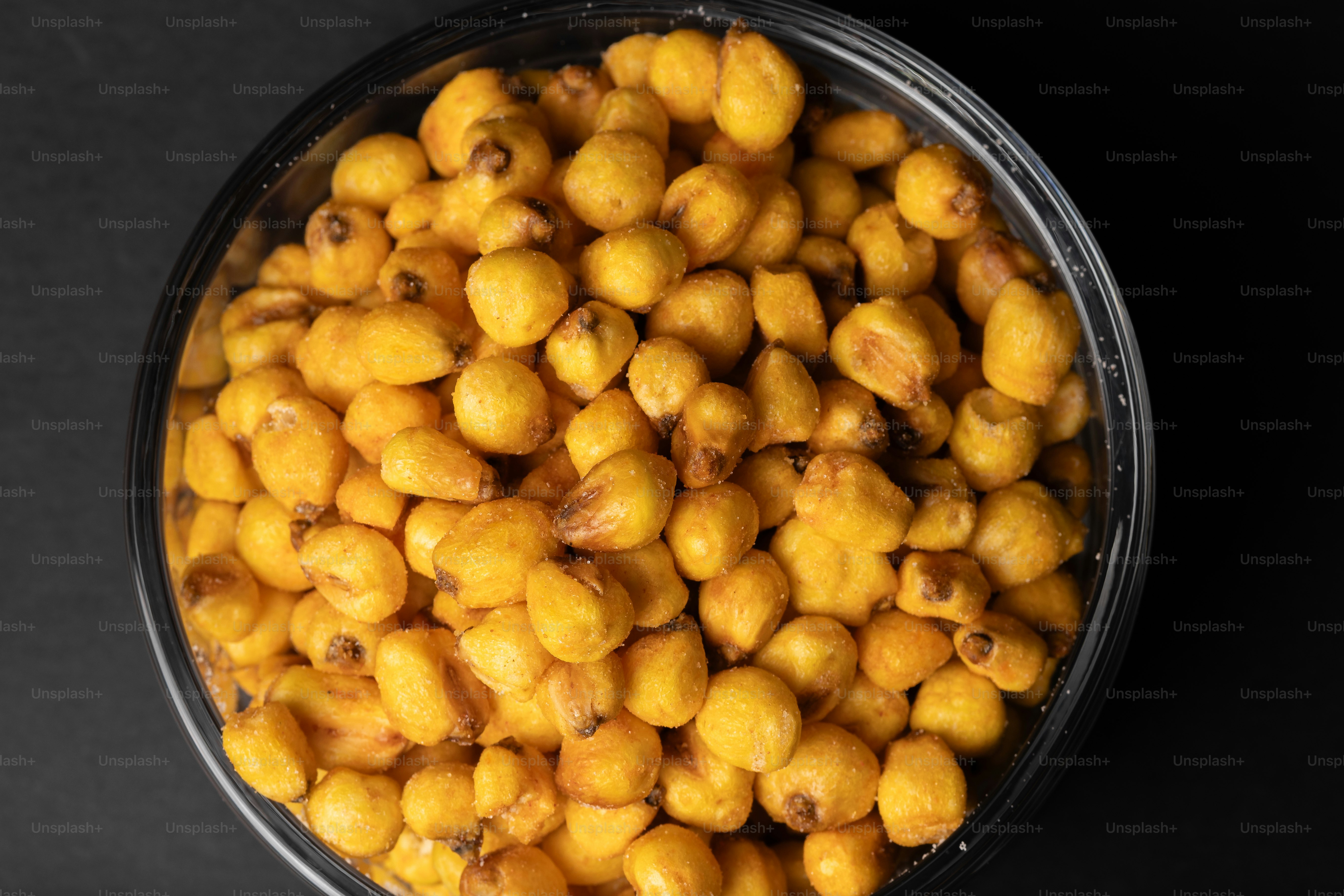 Roasted corn kernels in a black bowl