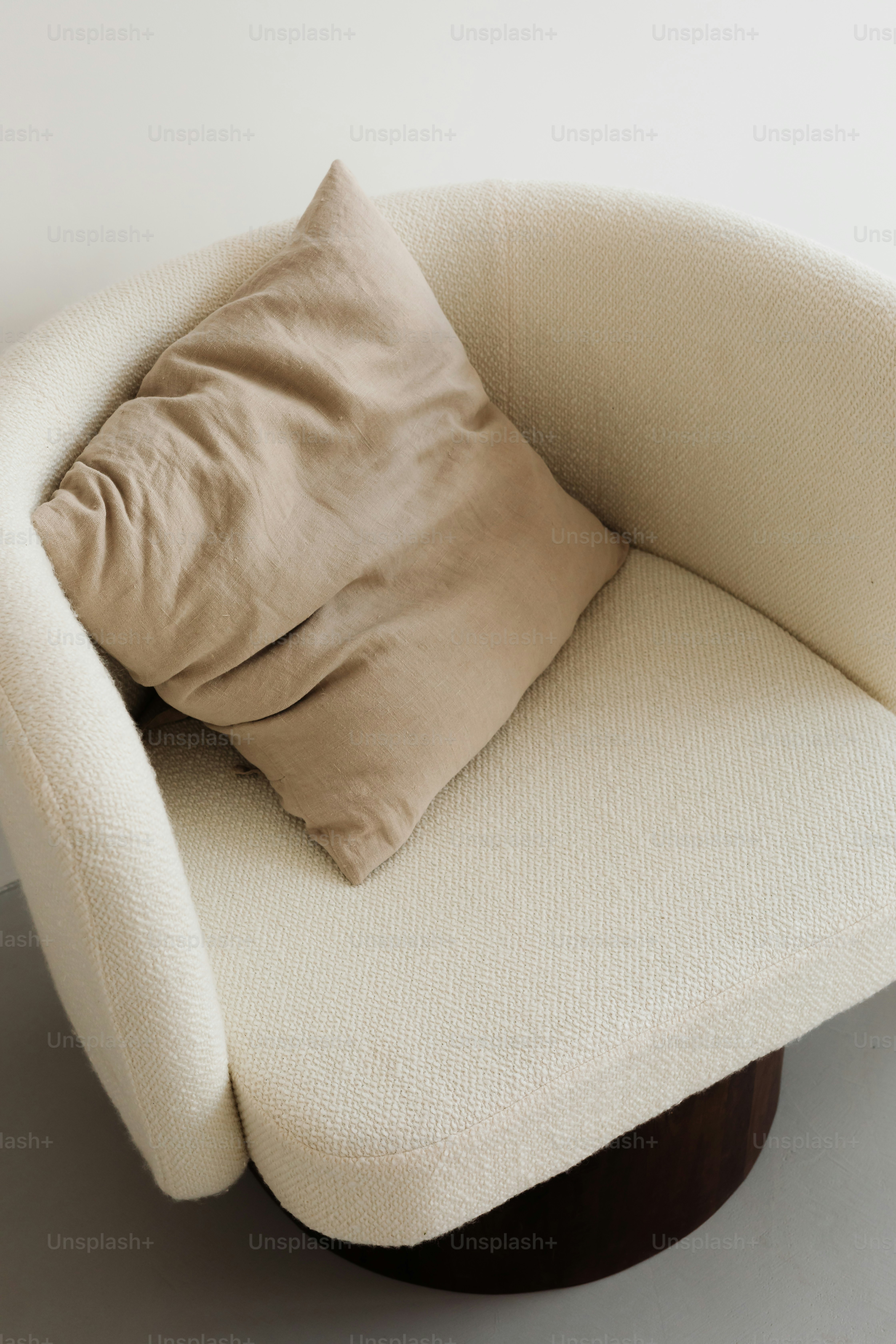 Cream armchair with a beige cushion