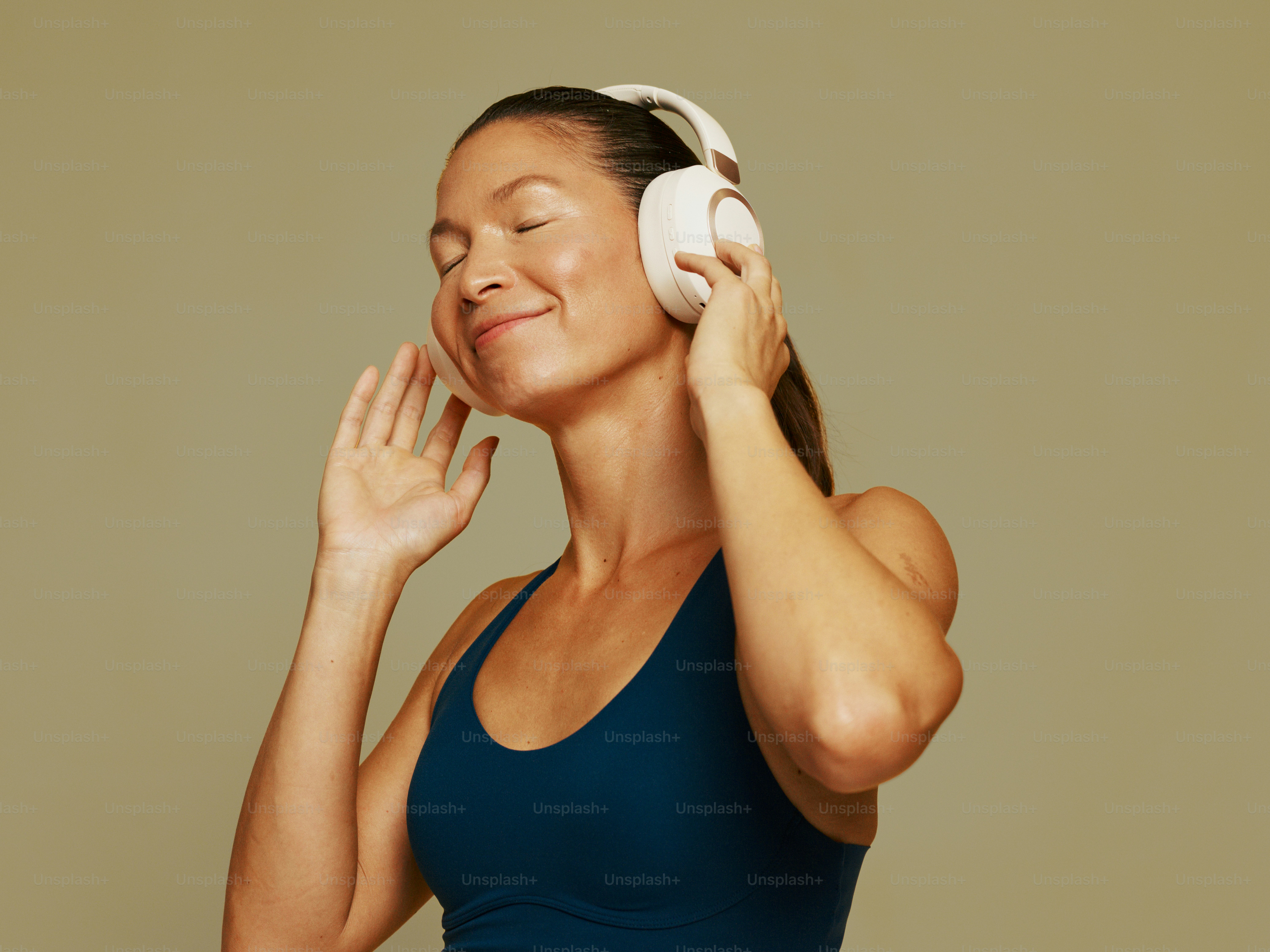 Woman with eyes closed listening to music on headphones