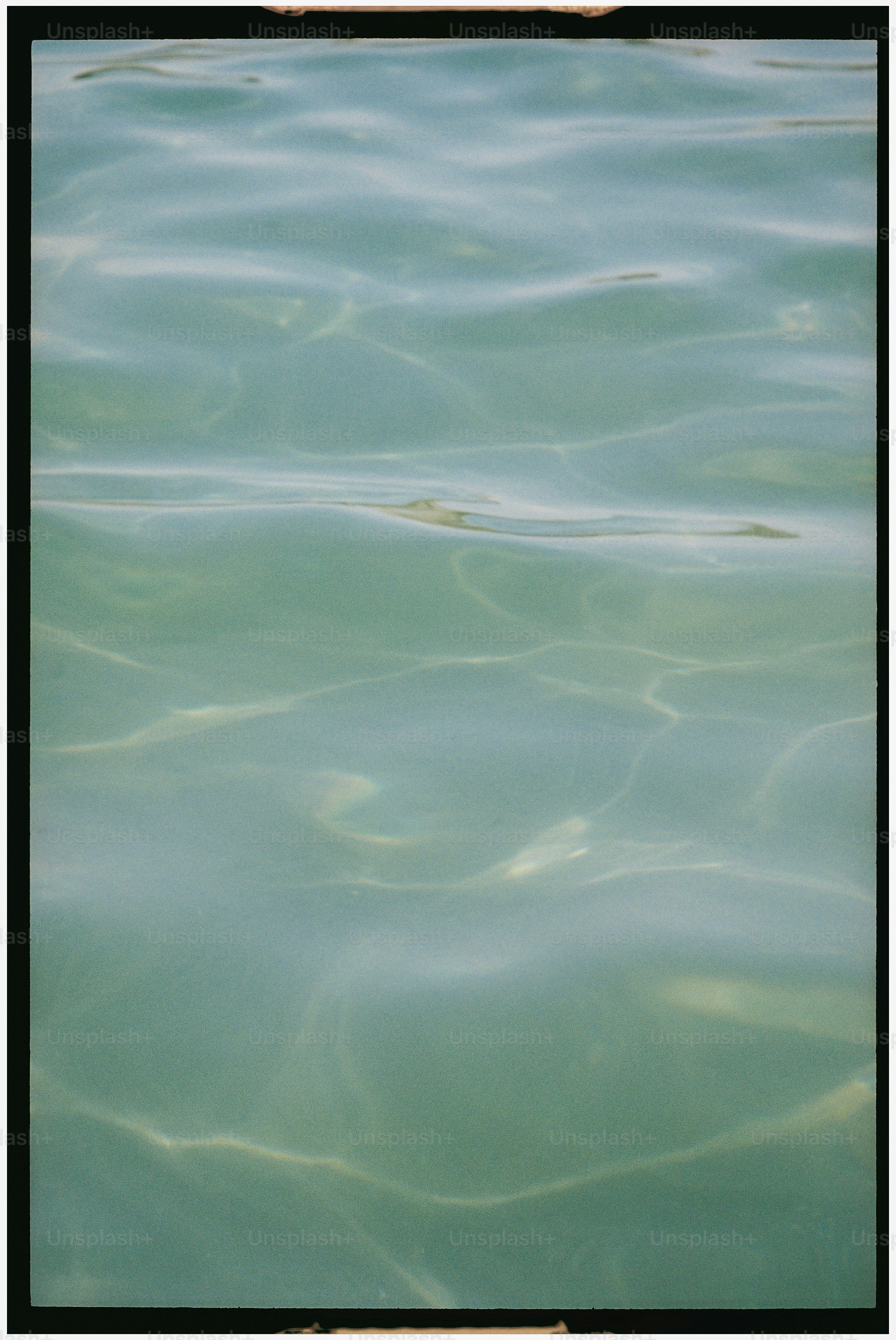 Rippling clear turquoise water with sunlight reflections