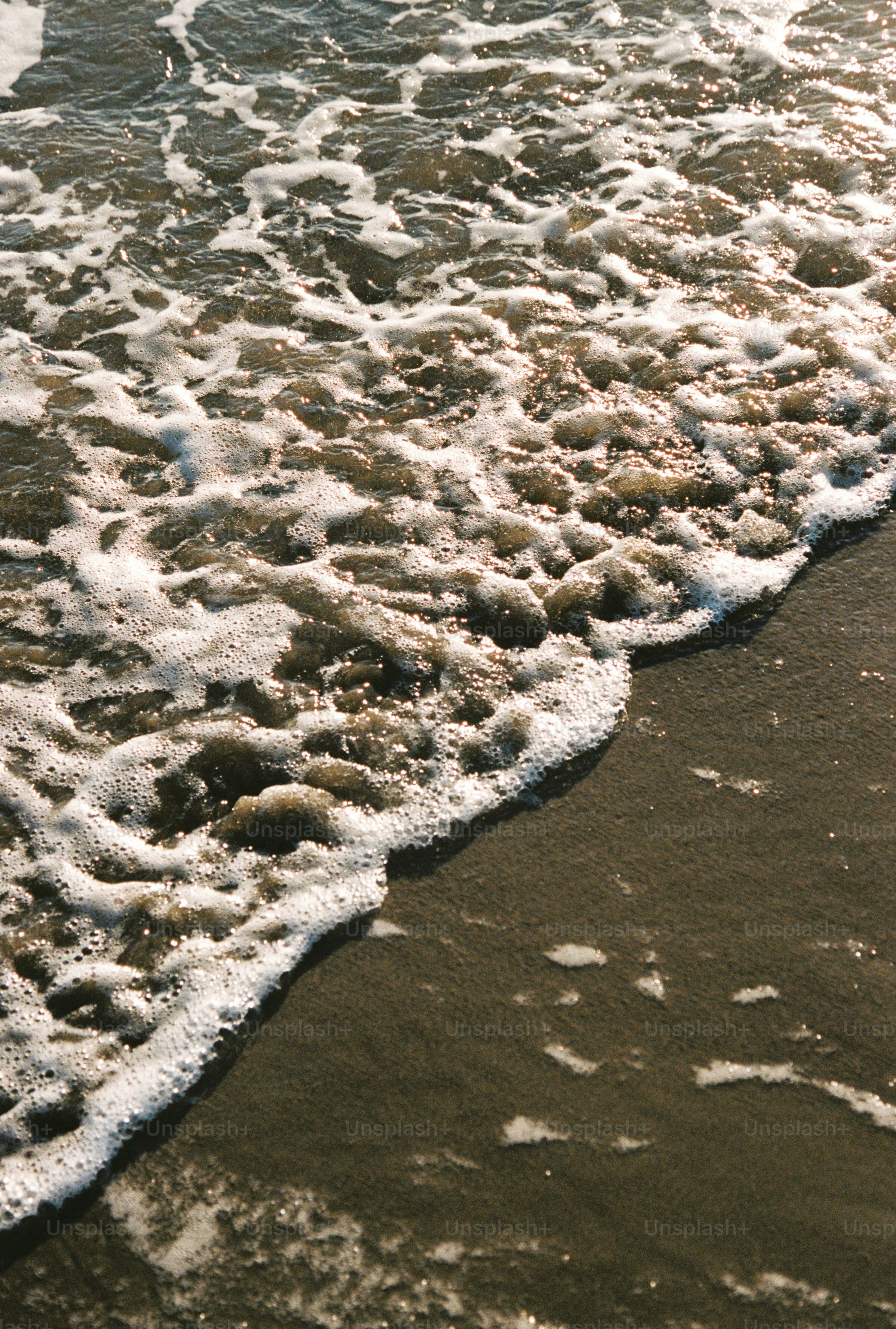 Ocean waves washing onto a sandy shore.