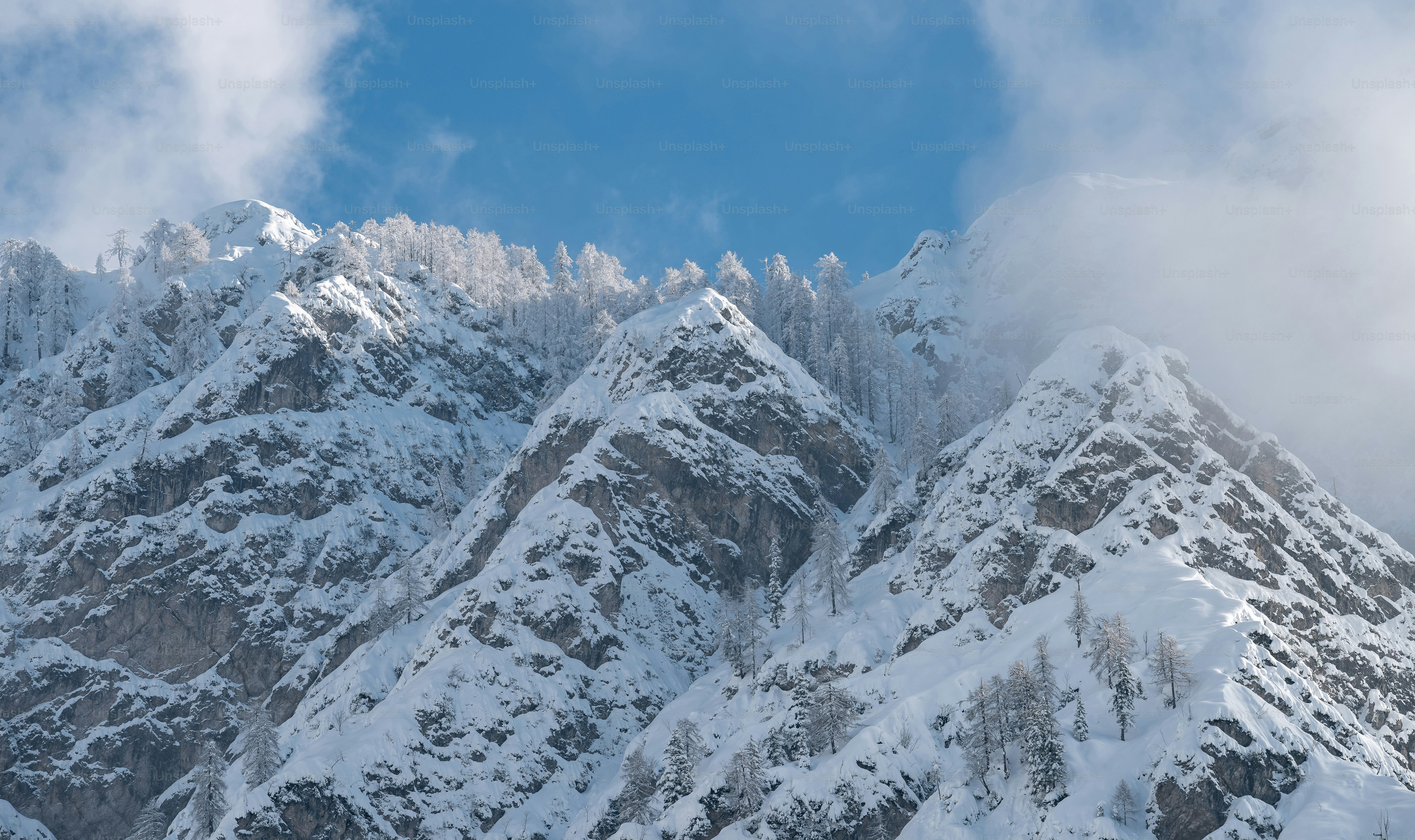 Snow-covered mountain peaks under a blue sky