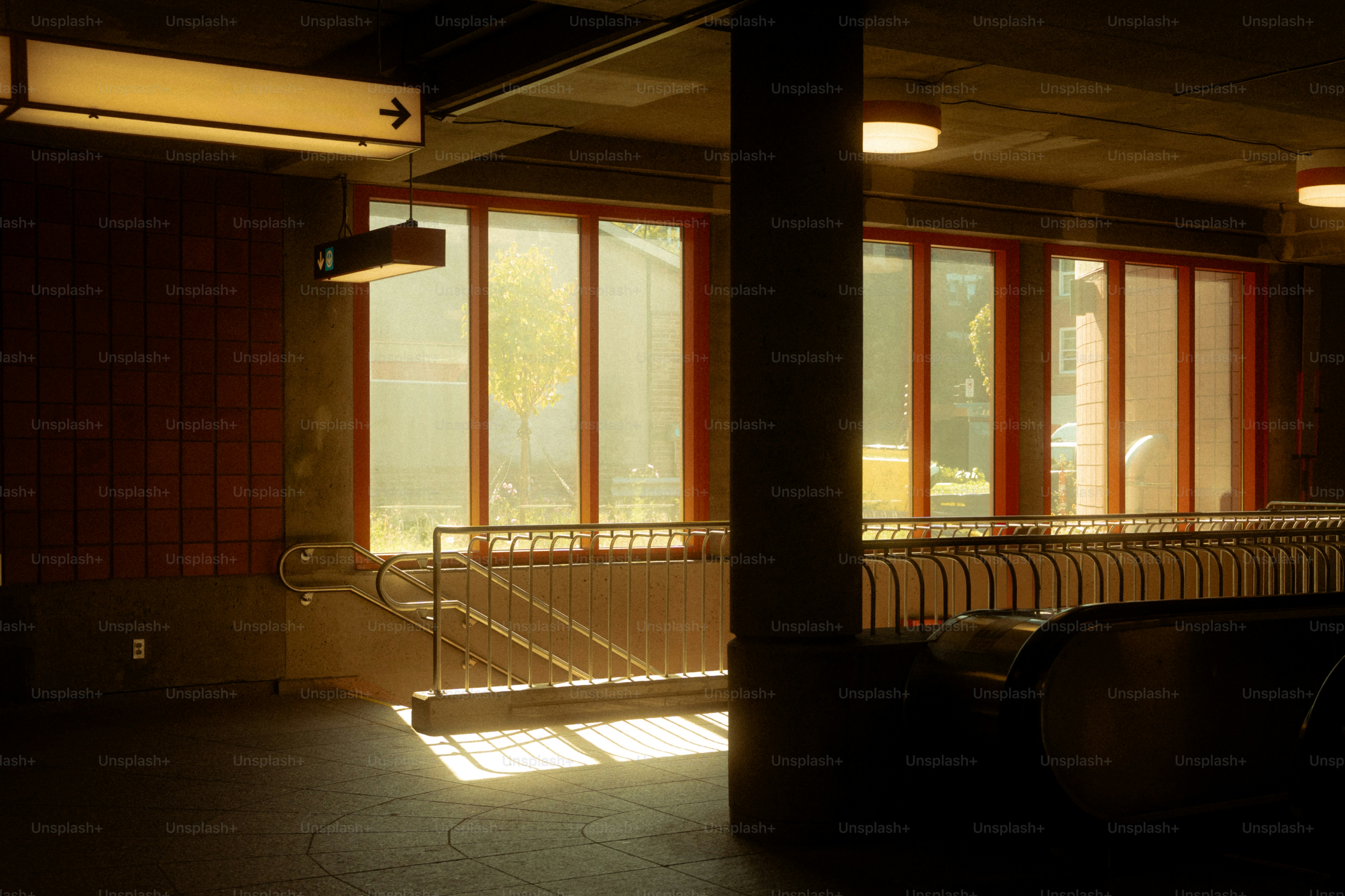 Sunlight streams through a subway station entrance.