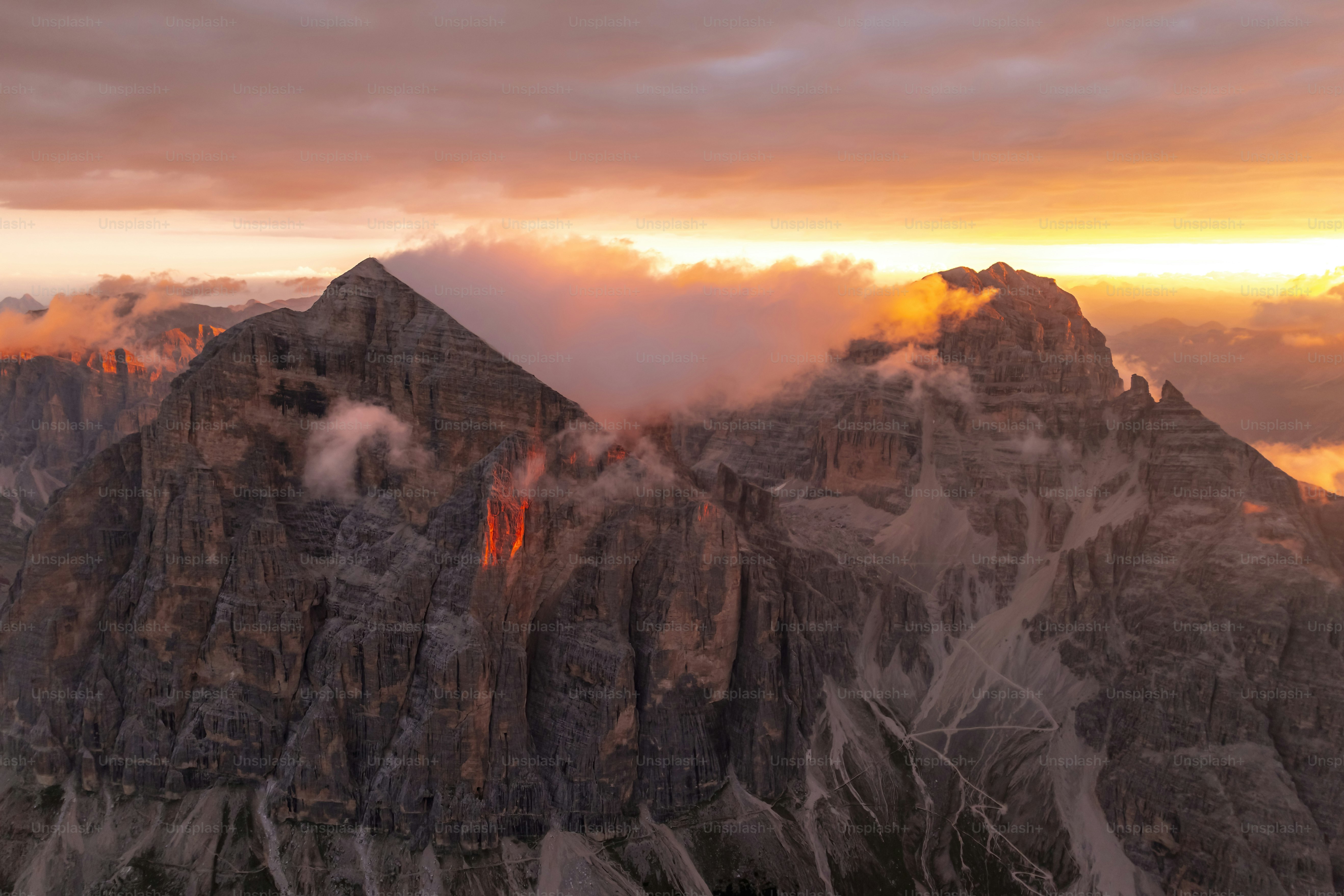 Majestic mountain peaks bathed in warm sunset light. photo – Wallpaper ...