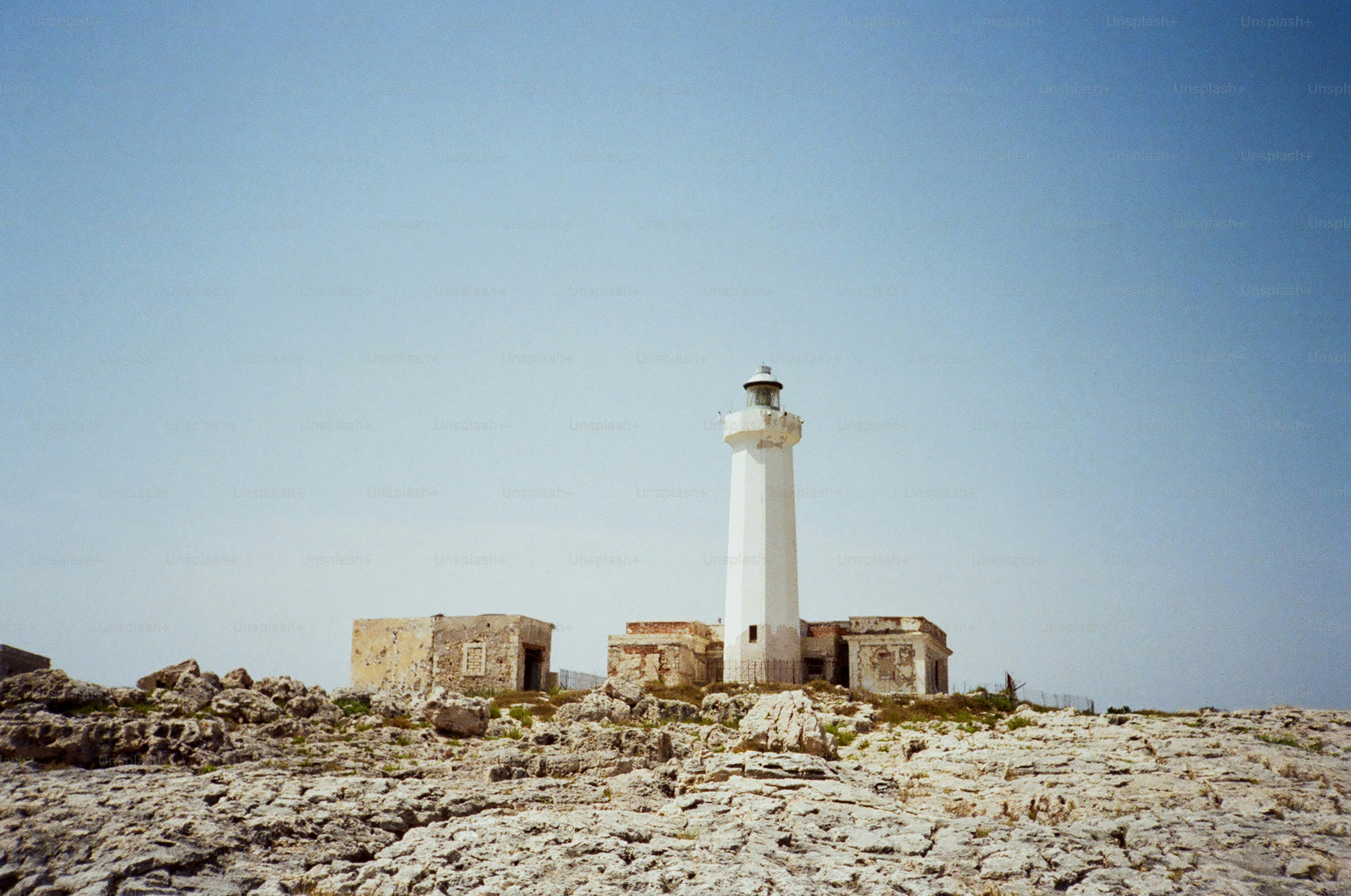 White lighthouse on a rocky shore
