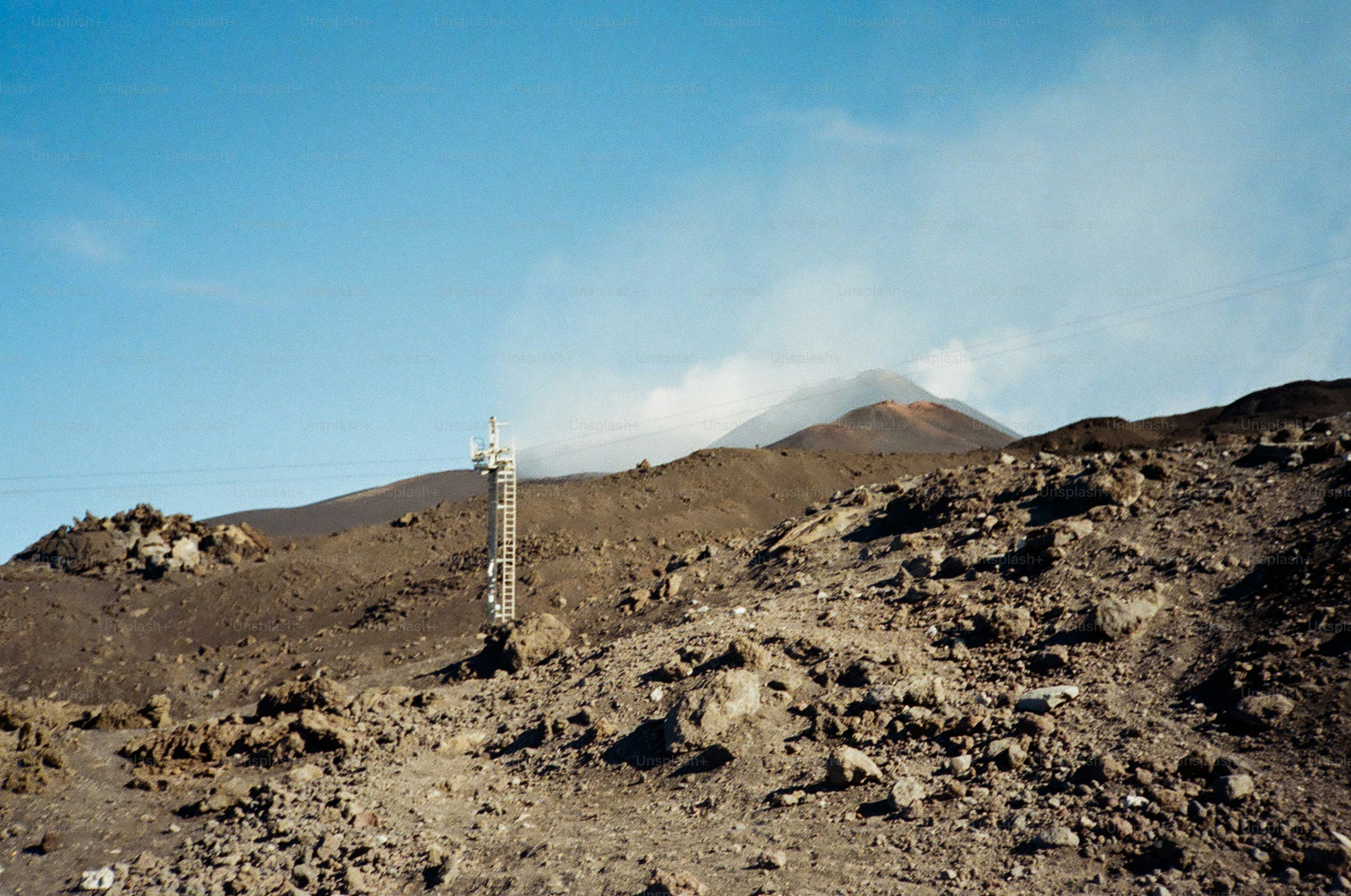 Volcanic landscape with a distant smoking peak.