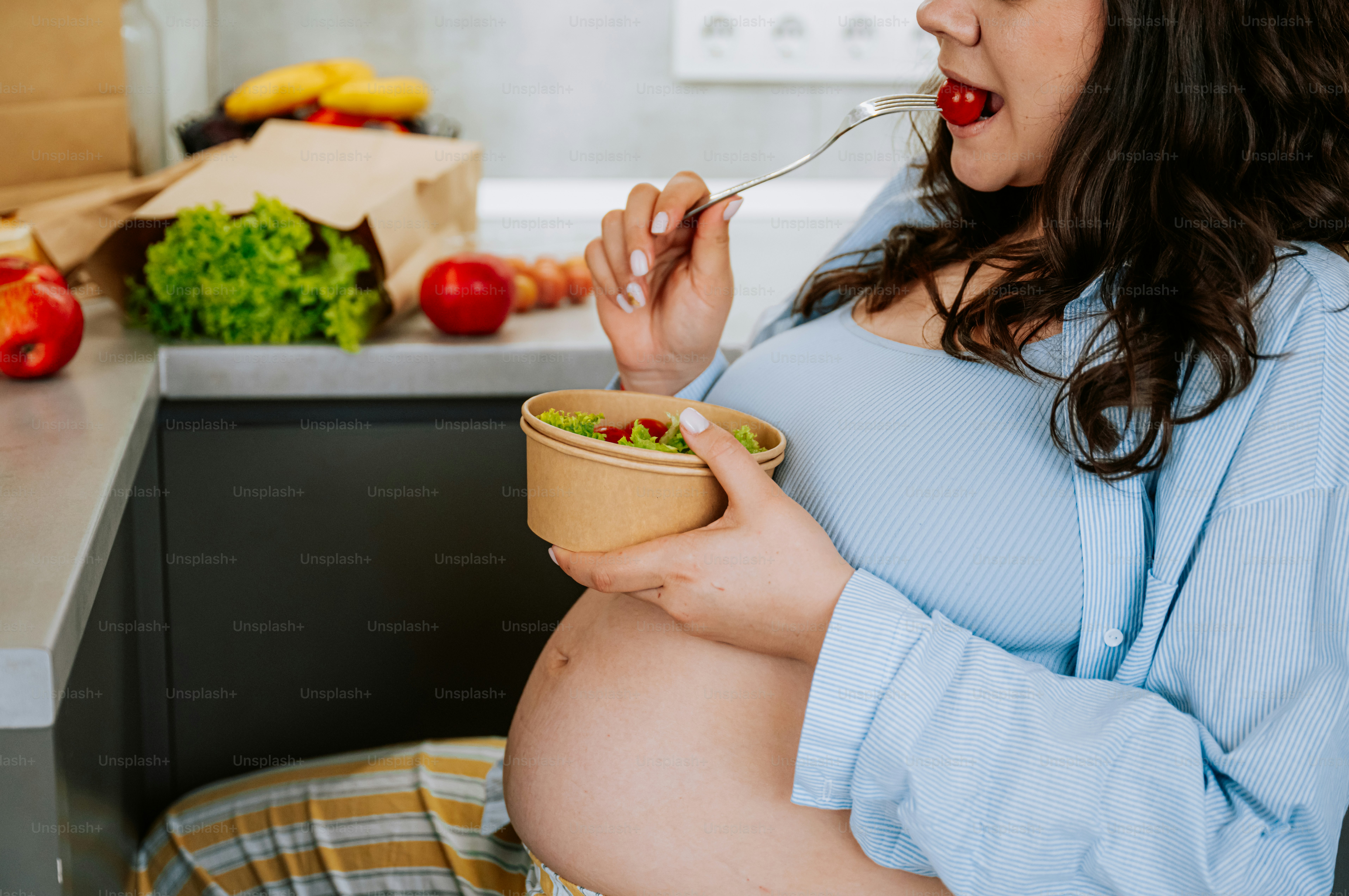 Pregnant woman eating a healthy salad