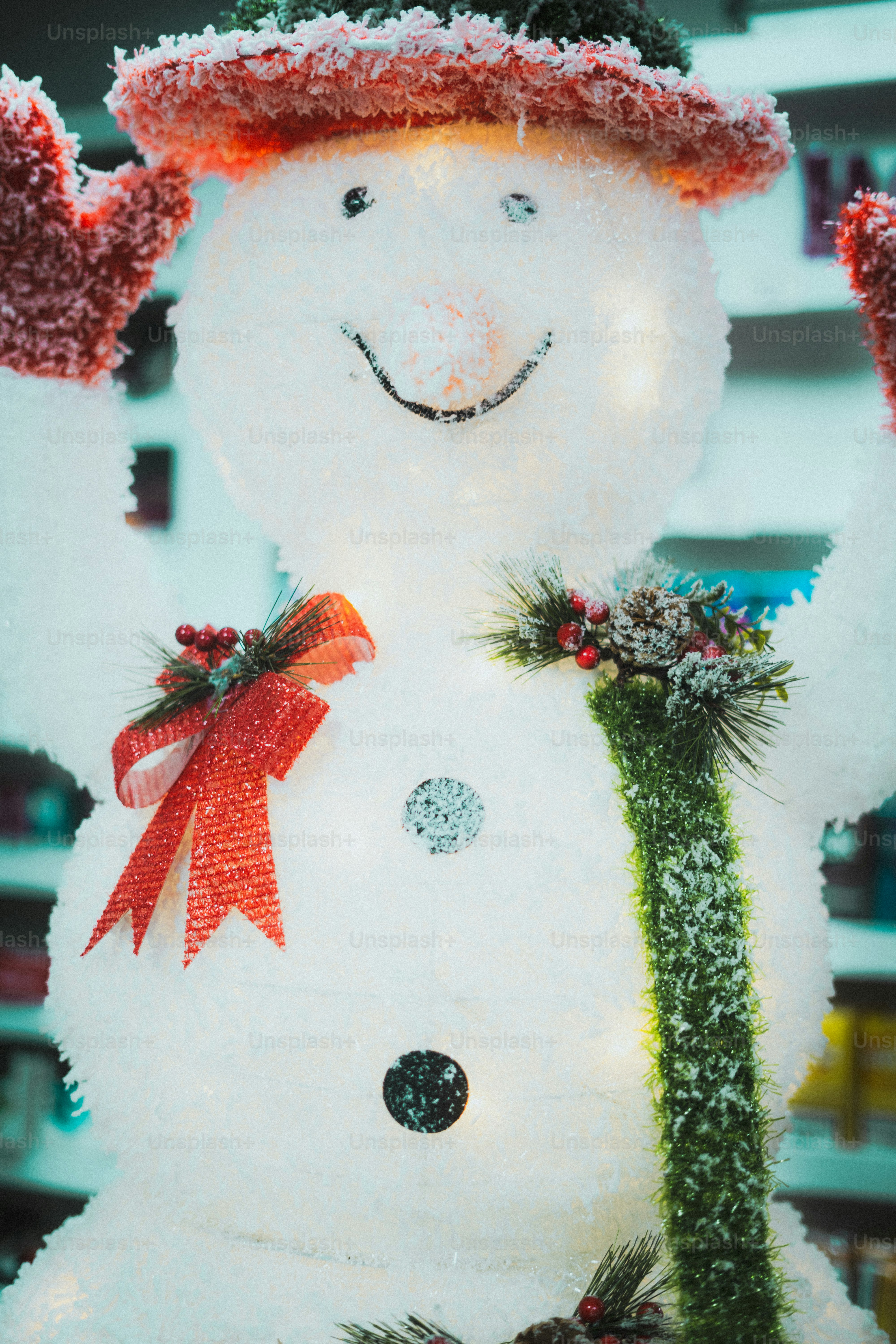 A festive snowman decoration with a red hat and mittens.