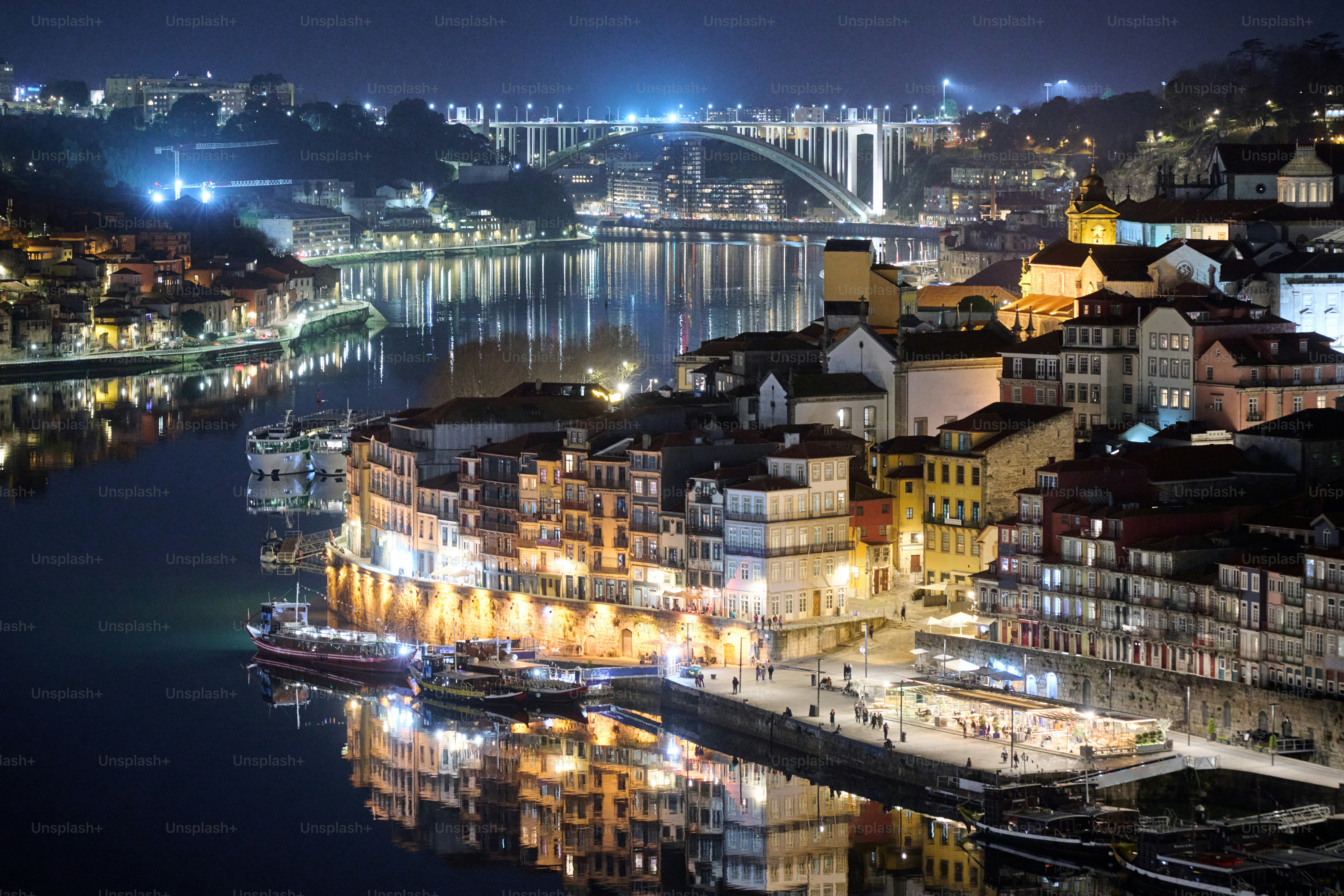 Cityscape with river and bridge at night