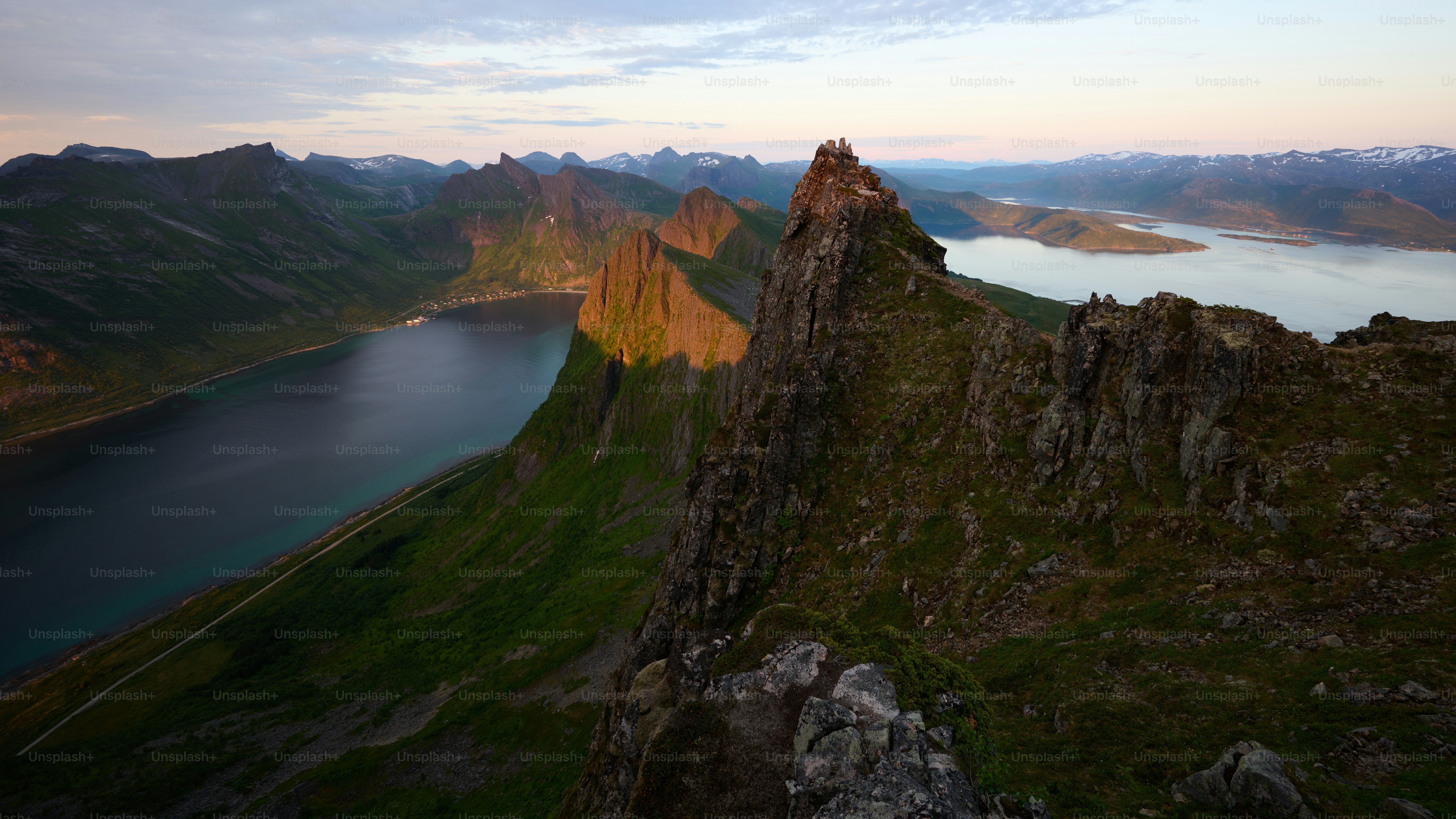 Jagged mountain peaks with a fjord at sunrise