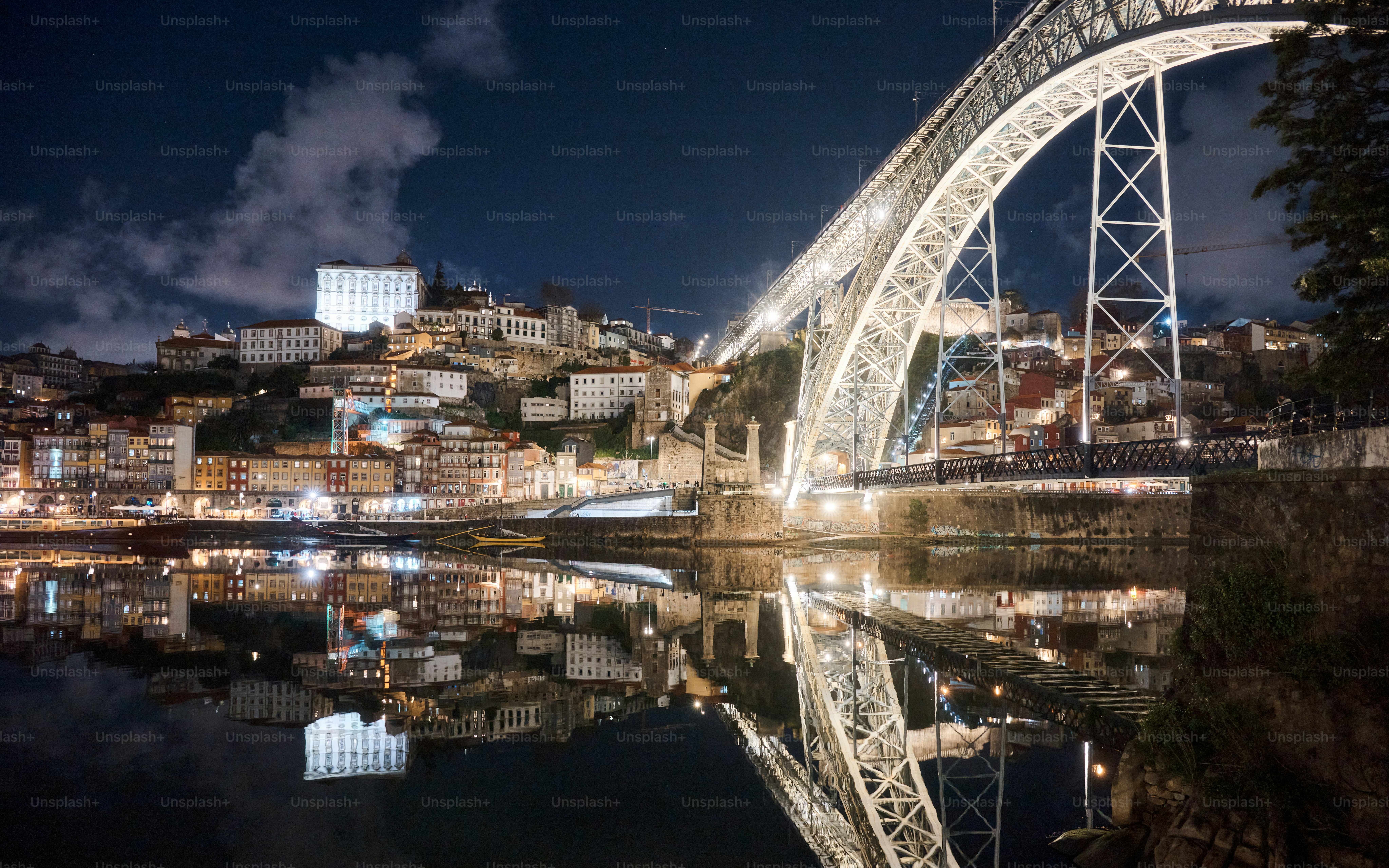 Night view of a bridge reflected in water