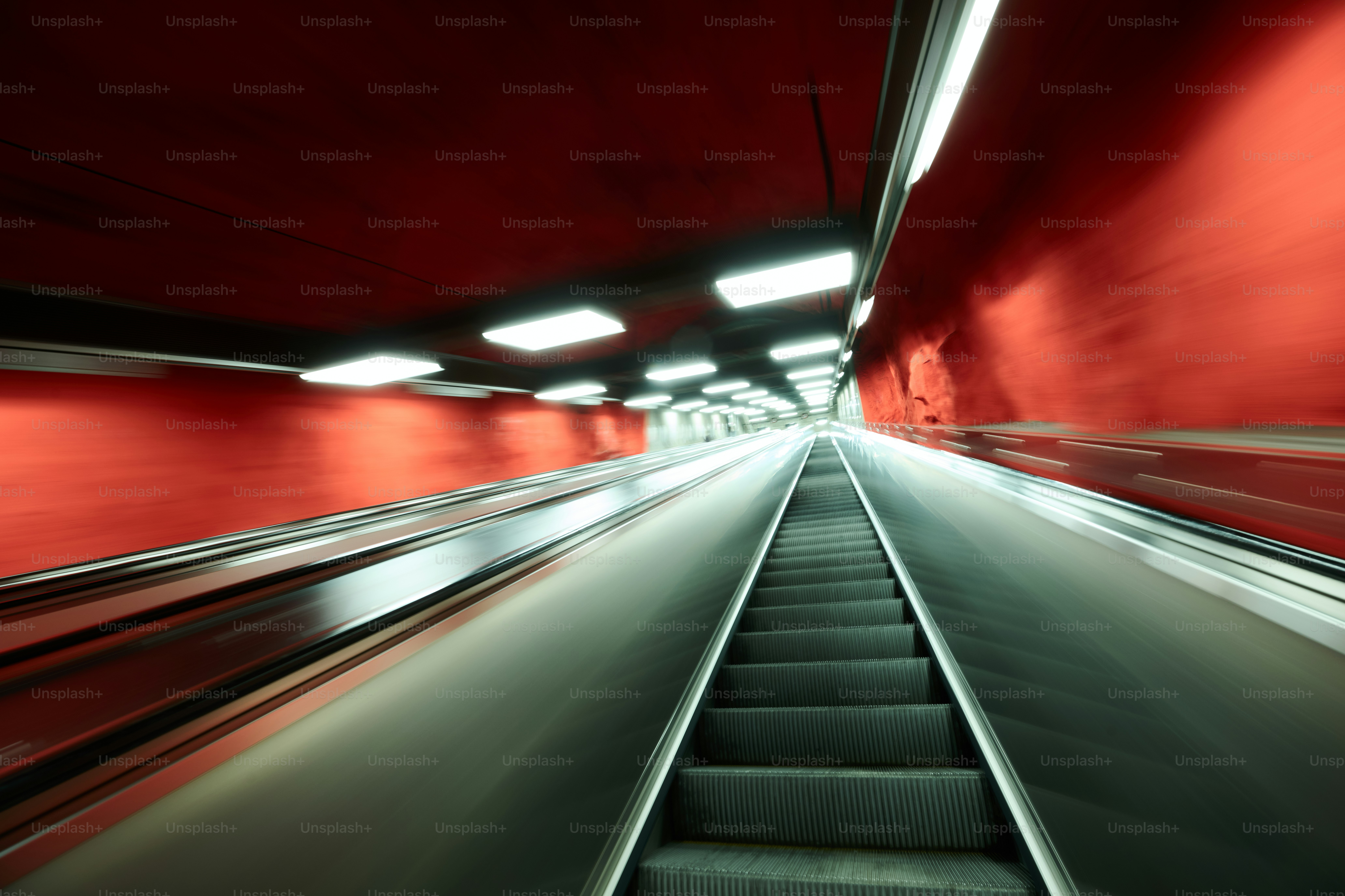 Escalator in a modern red subway station