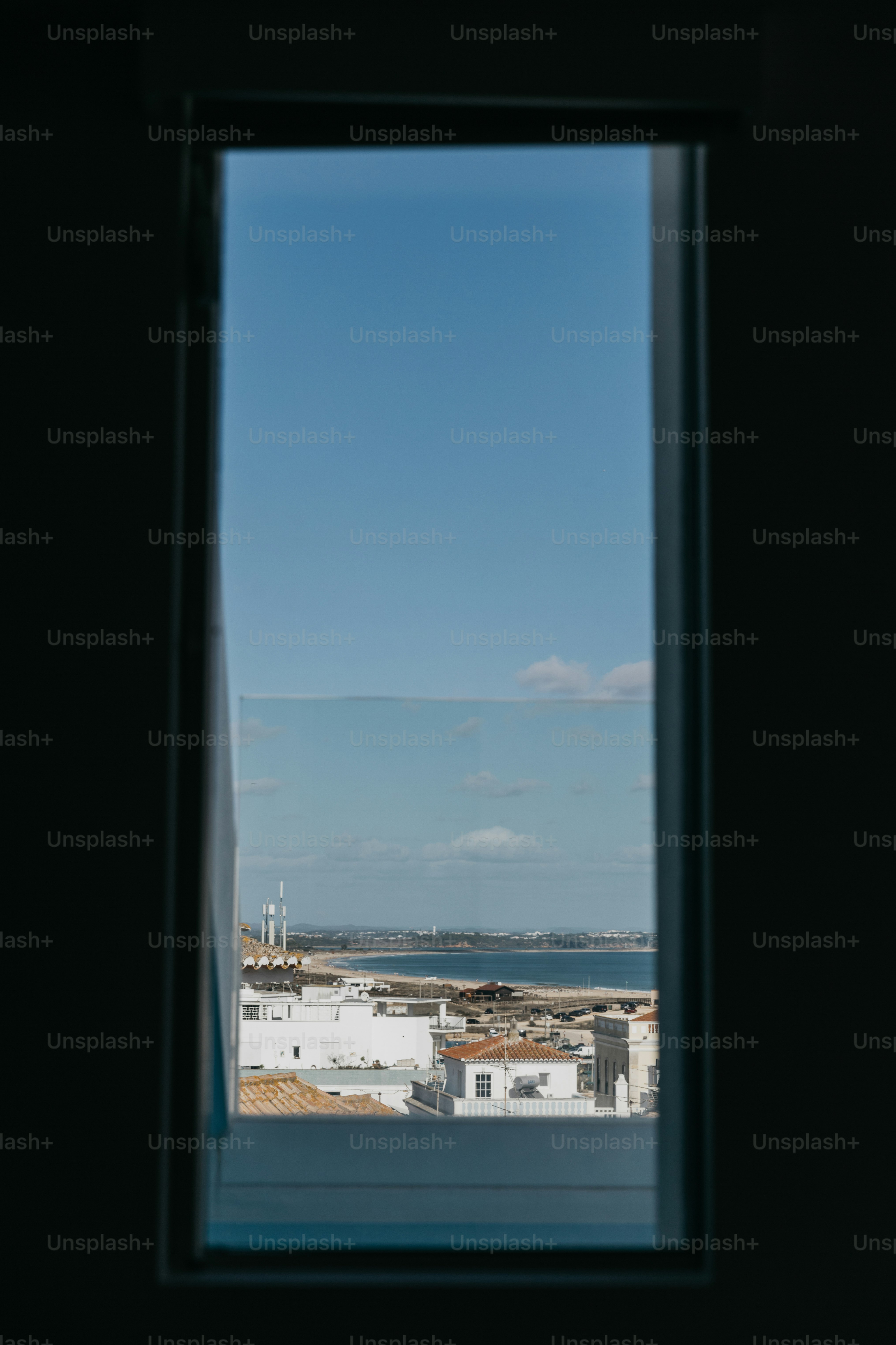 View of a coastal town through a window. photo – Image on Unsplash