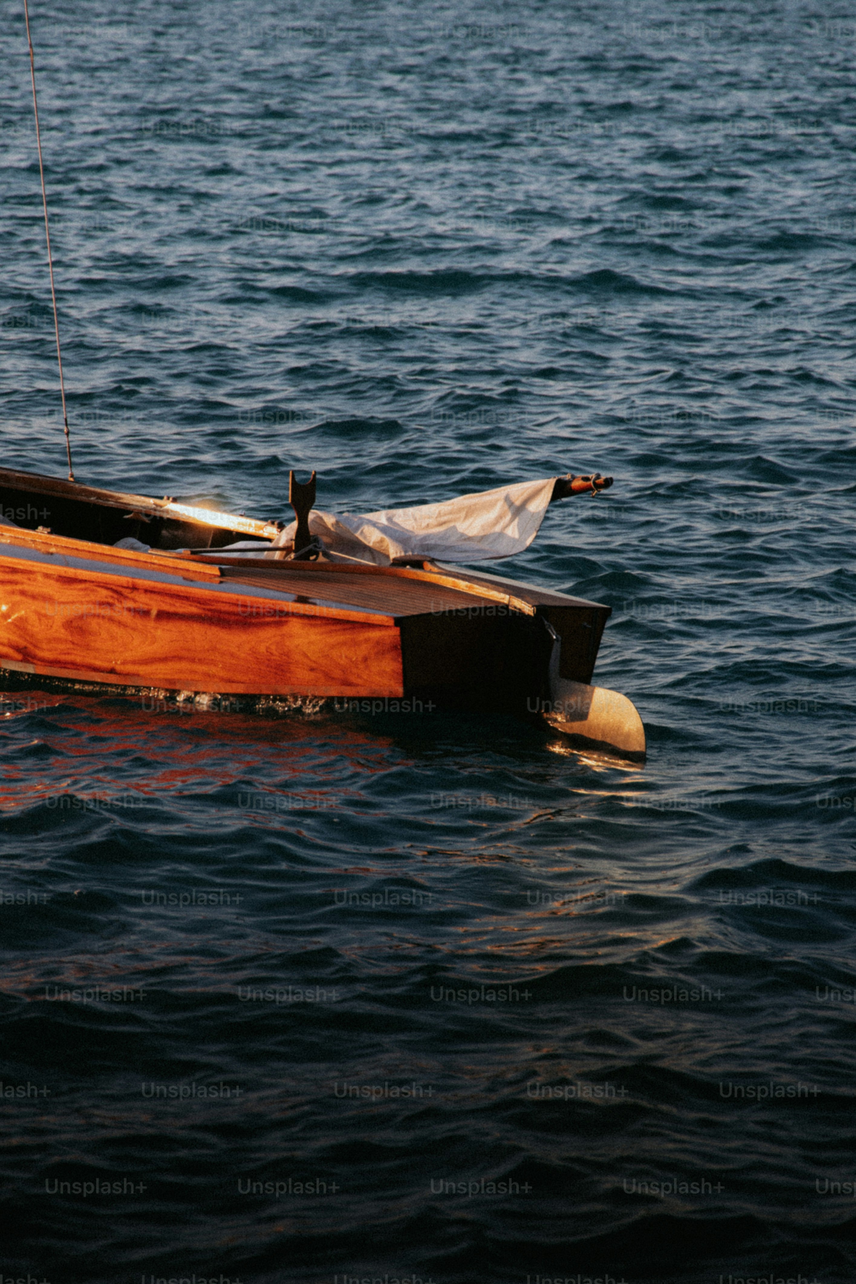 Wooden boat sailing on dark blue water