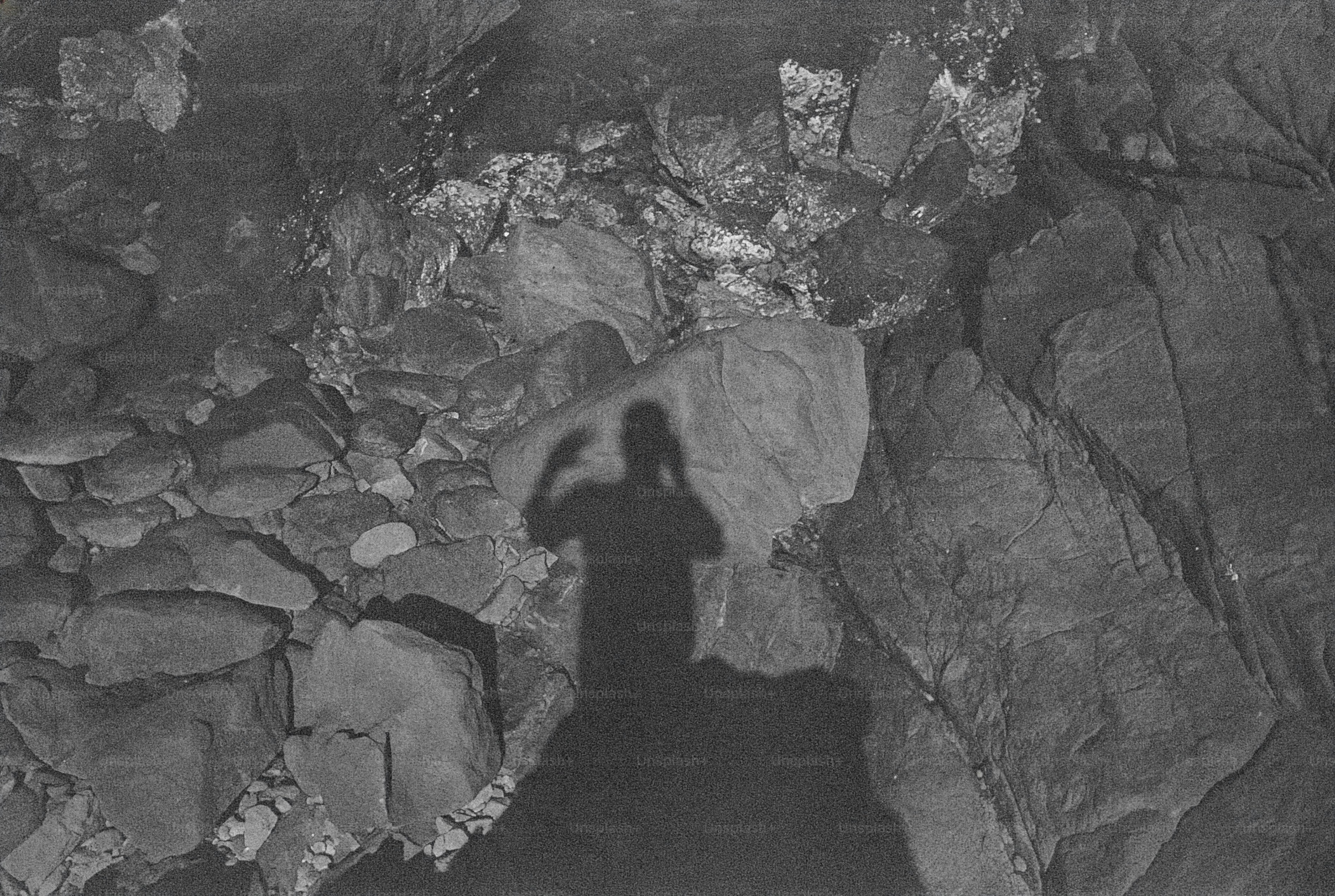 Shadow of a person among rocks in a cave