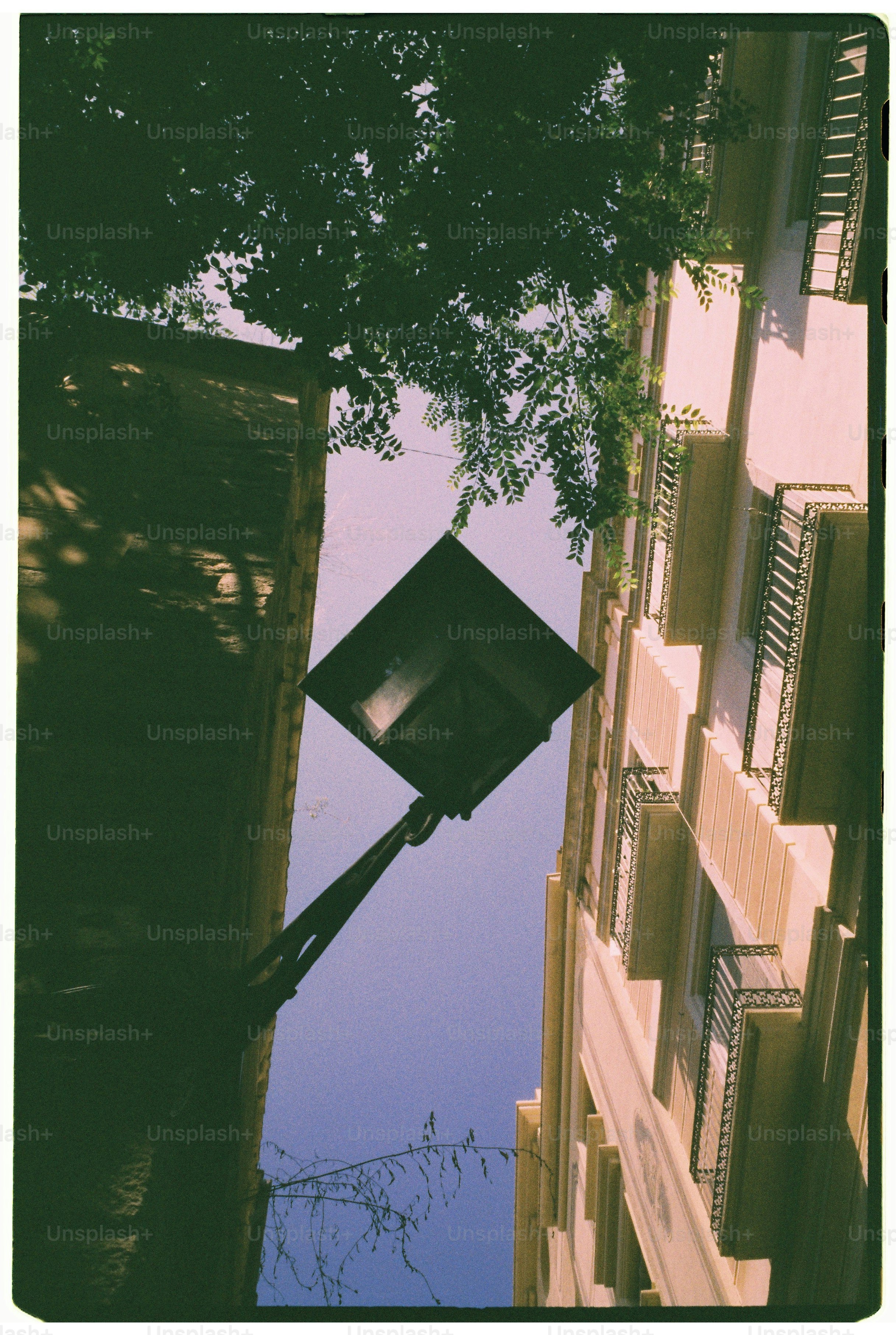 Street lamp between buildings with sky above