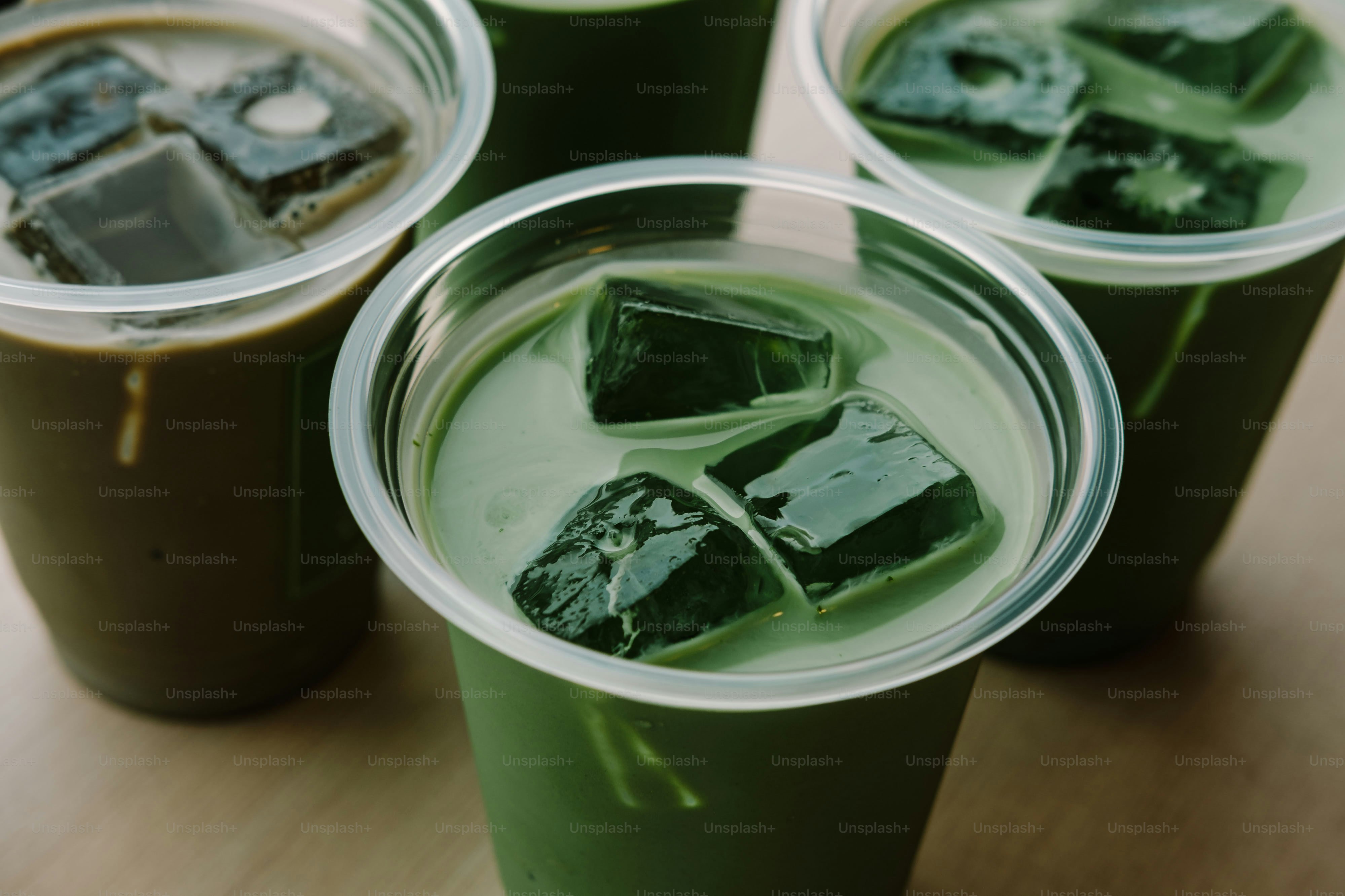 Iced matcha green tea drinks with ice cubes.