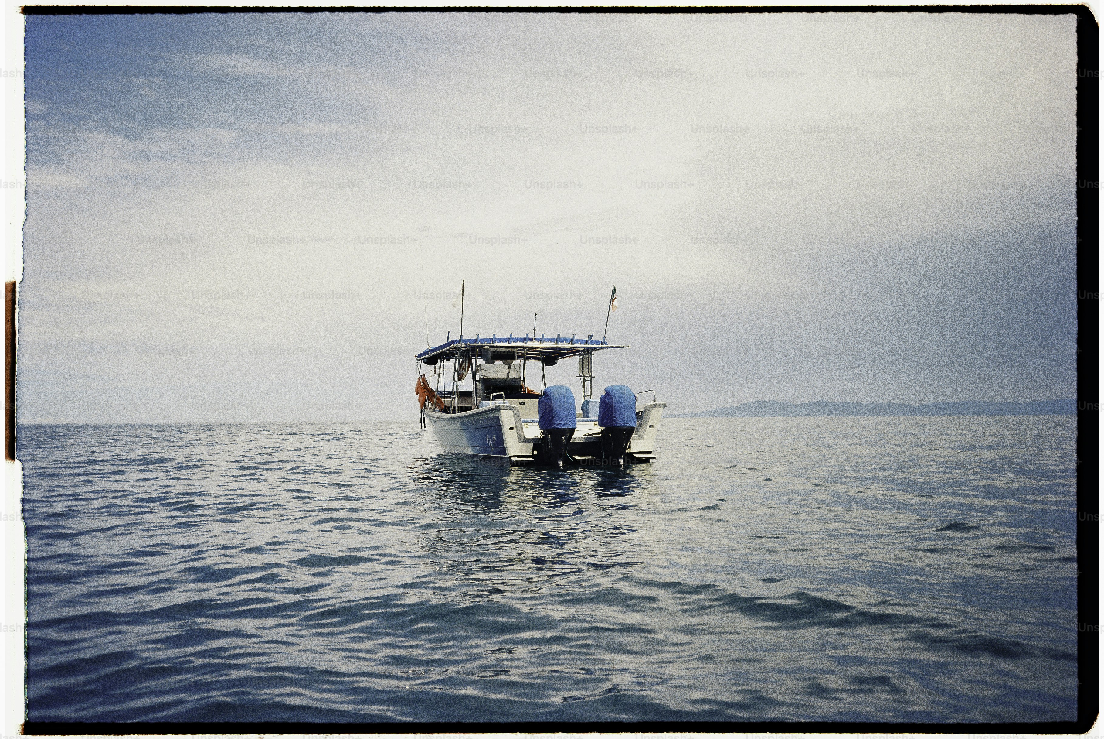 A fishing boat rests on calm ocean waters.