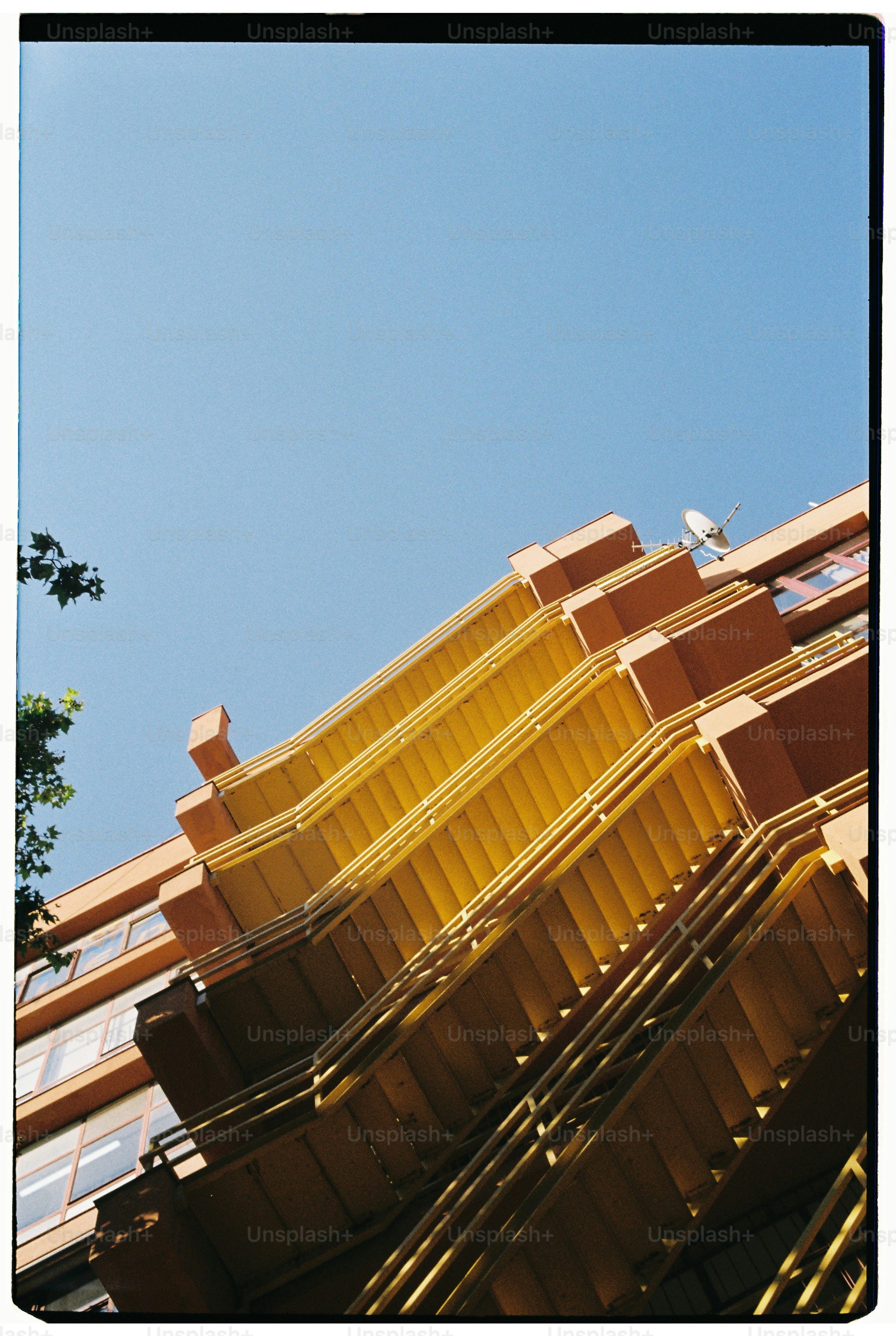 Orange building with yellow balconies against blue sky