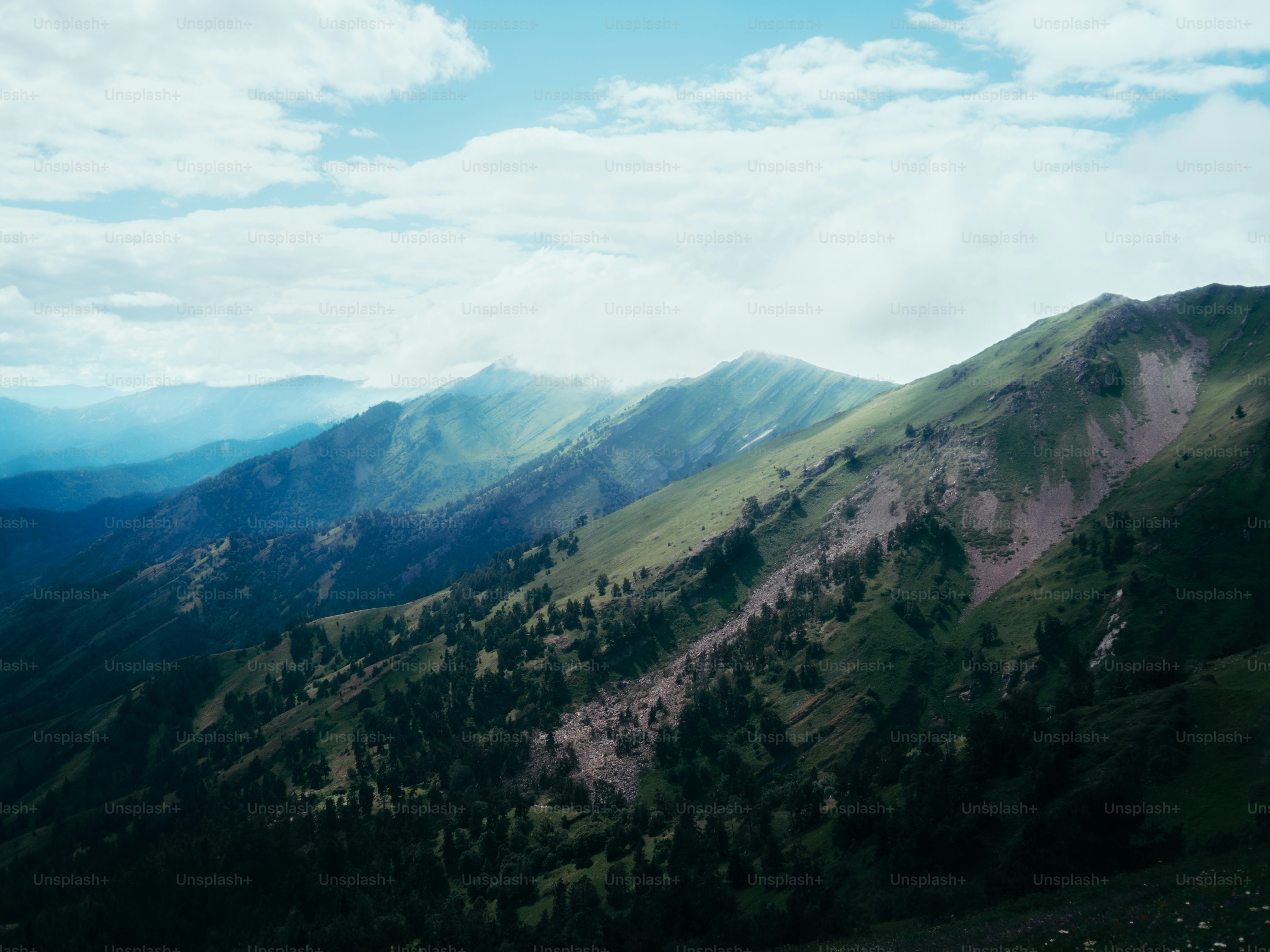 Rolling green mountains under a cloudy sky