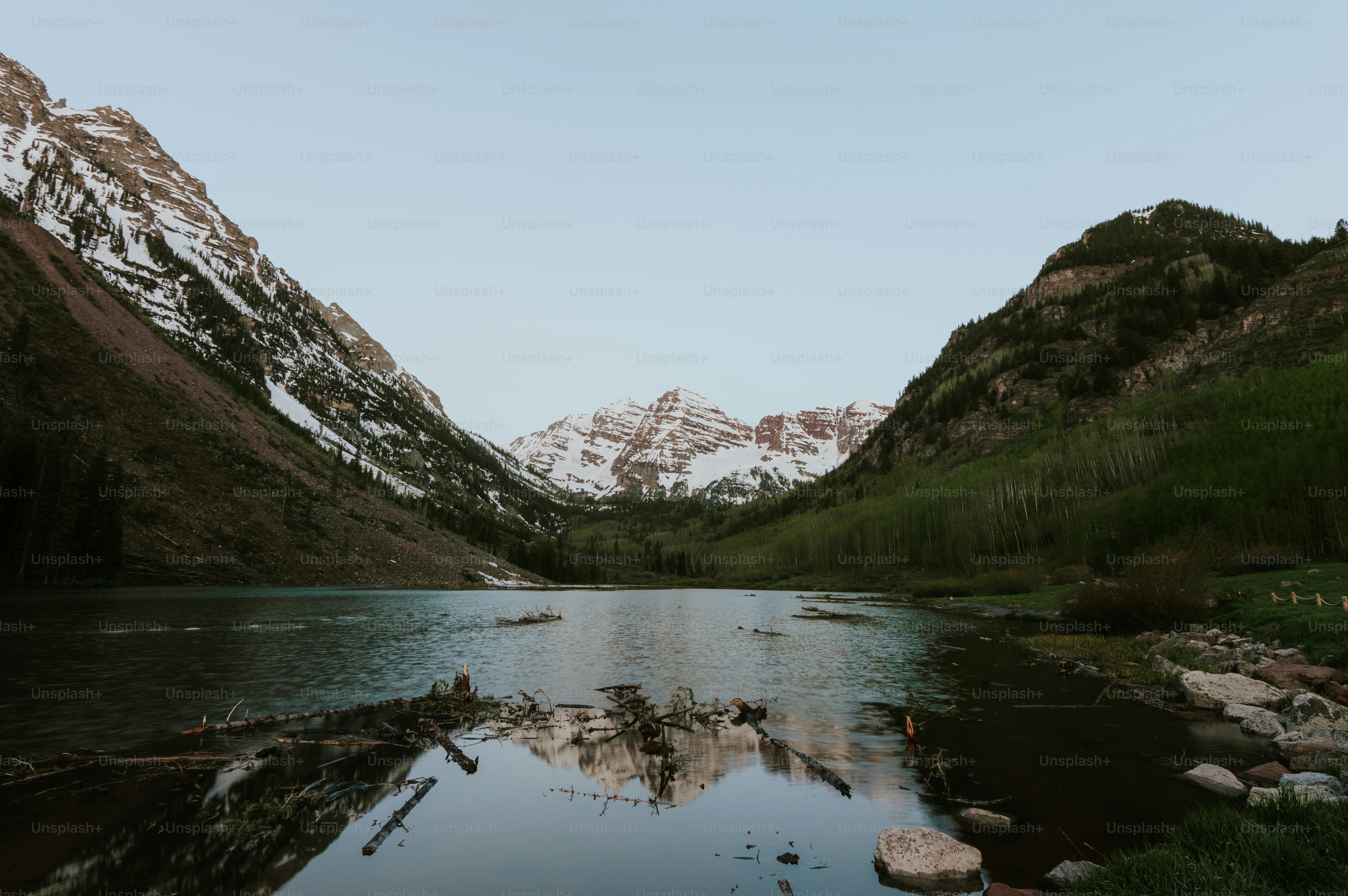 Snow-capped mountains reflected in a tranquil lake.