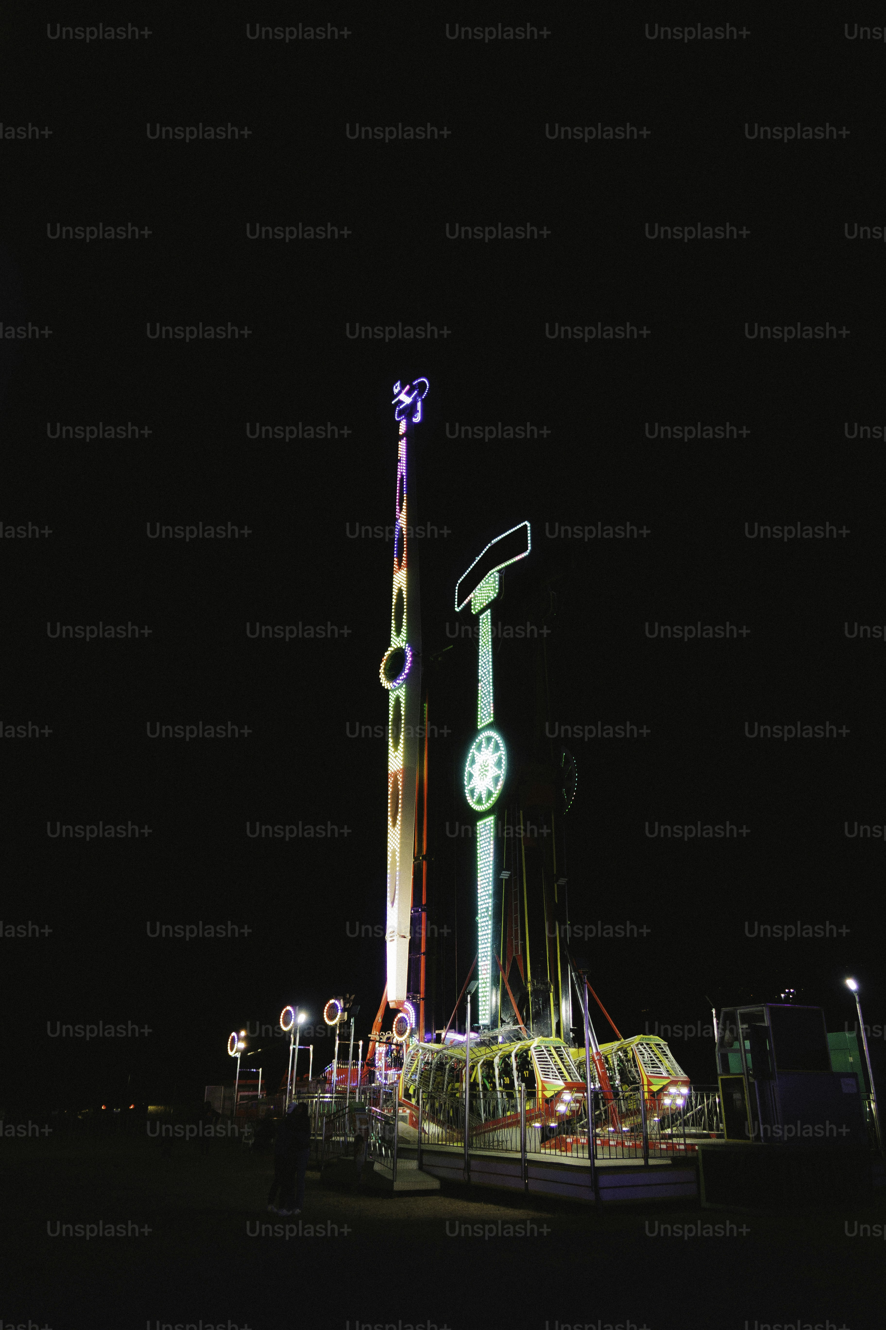 Amusement park rides illuminated at night