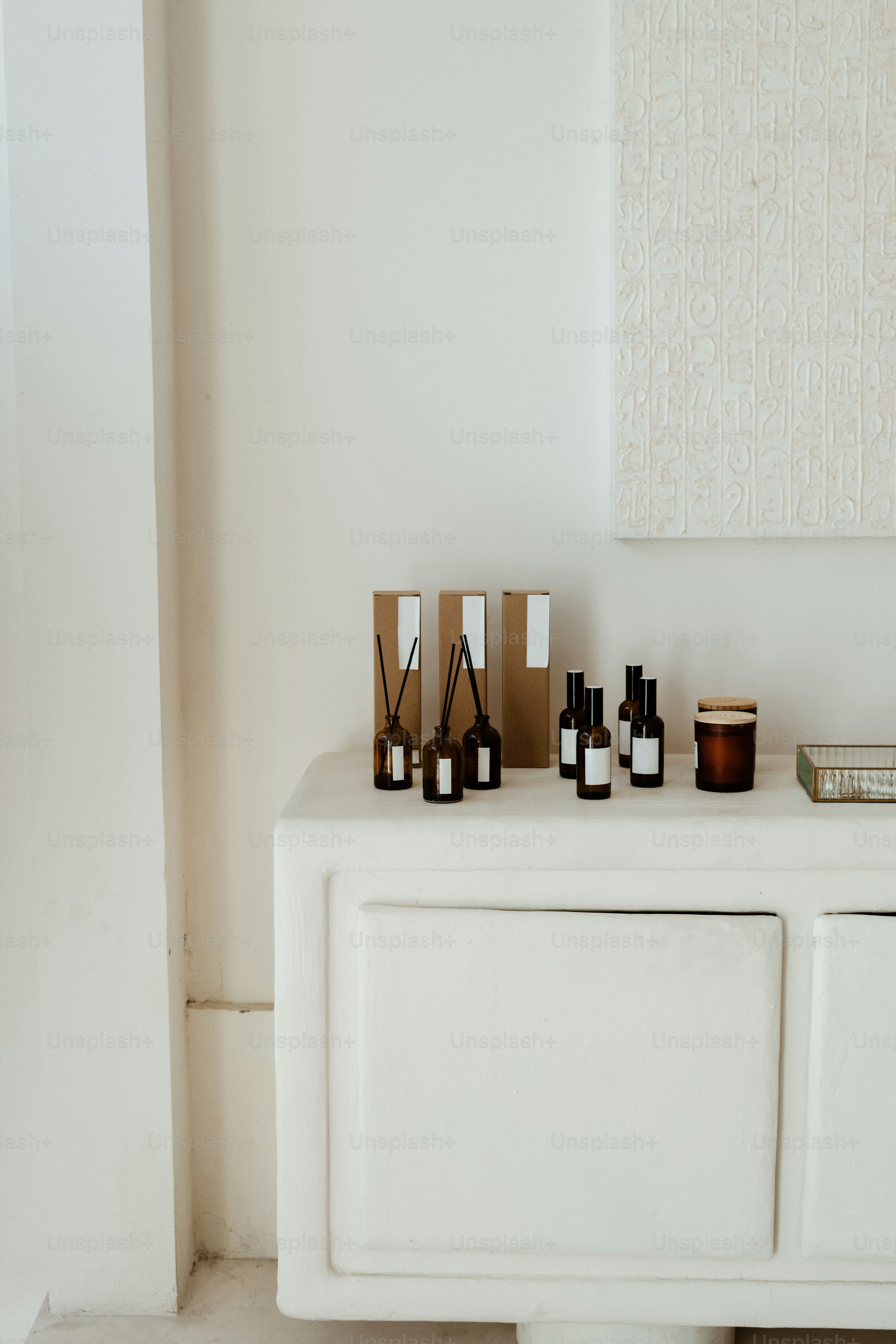 Various bottles and jars arranged on a white shelf.