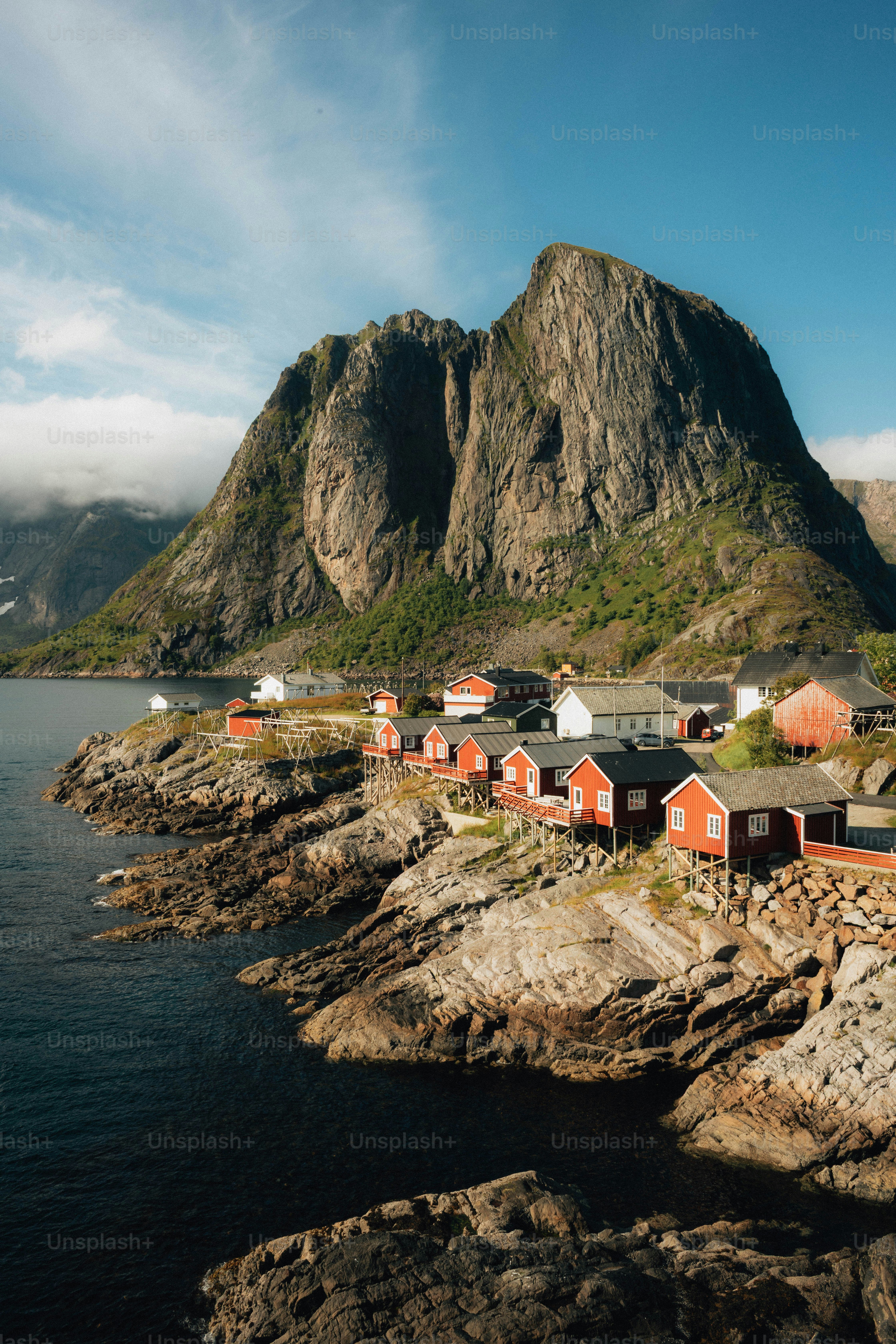 Red fishing village nestled at the base of a mountain