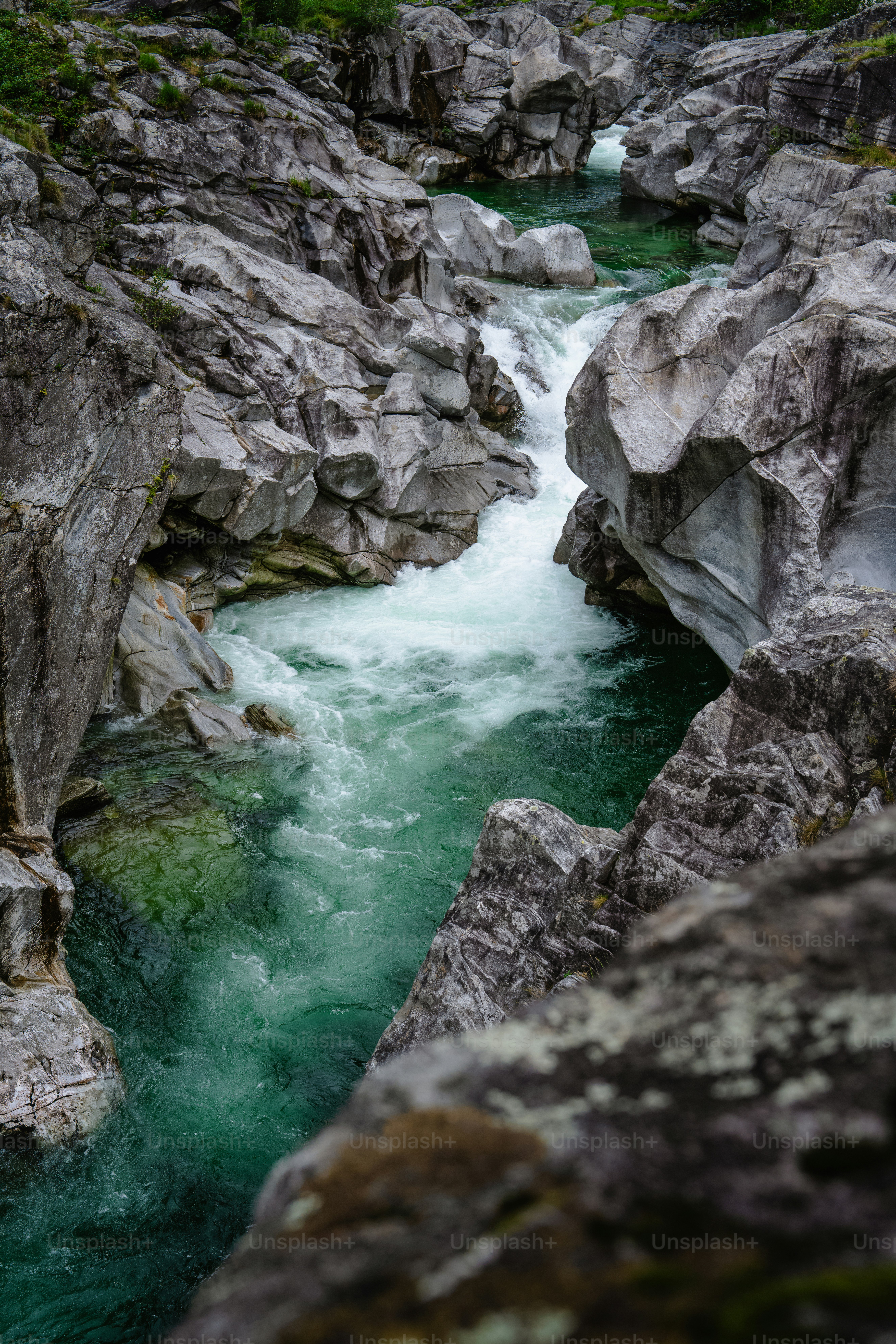 Turquoise water flows through a rocky gorge